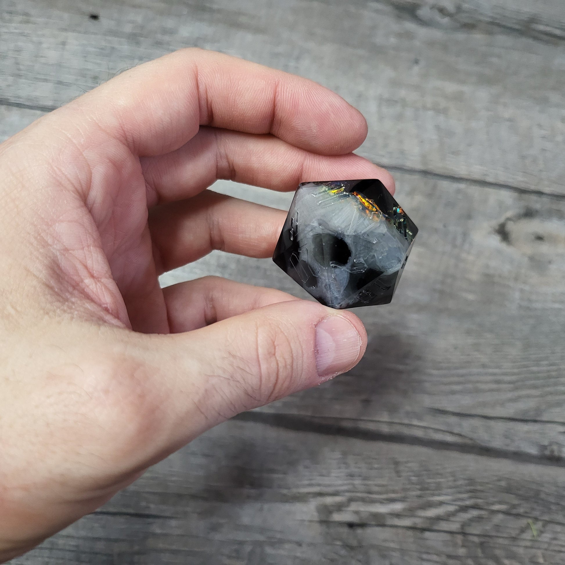 D20 dice in 33 mm format with skull inside for role-playing games for Dungeons and Dragons