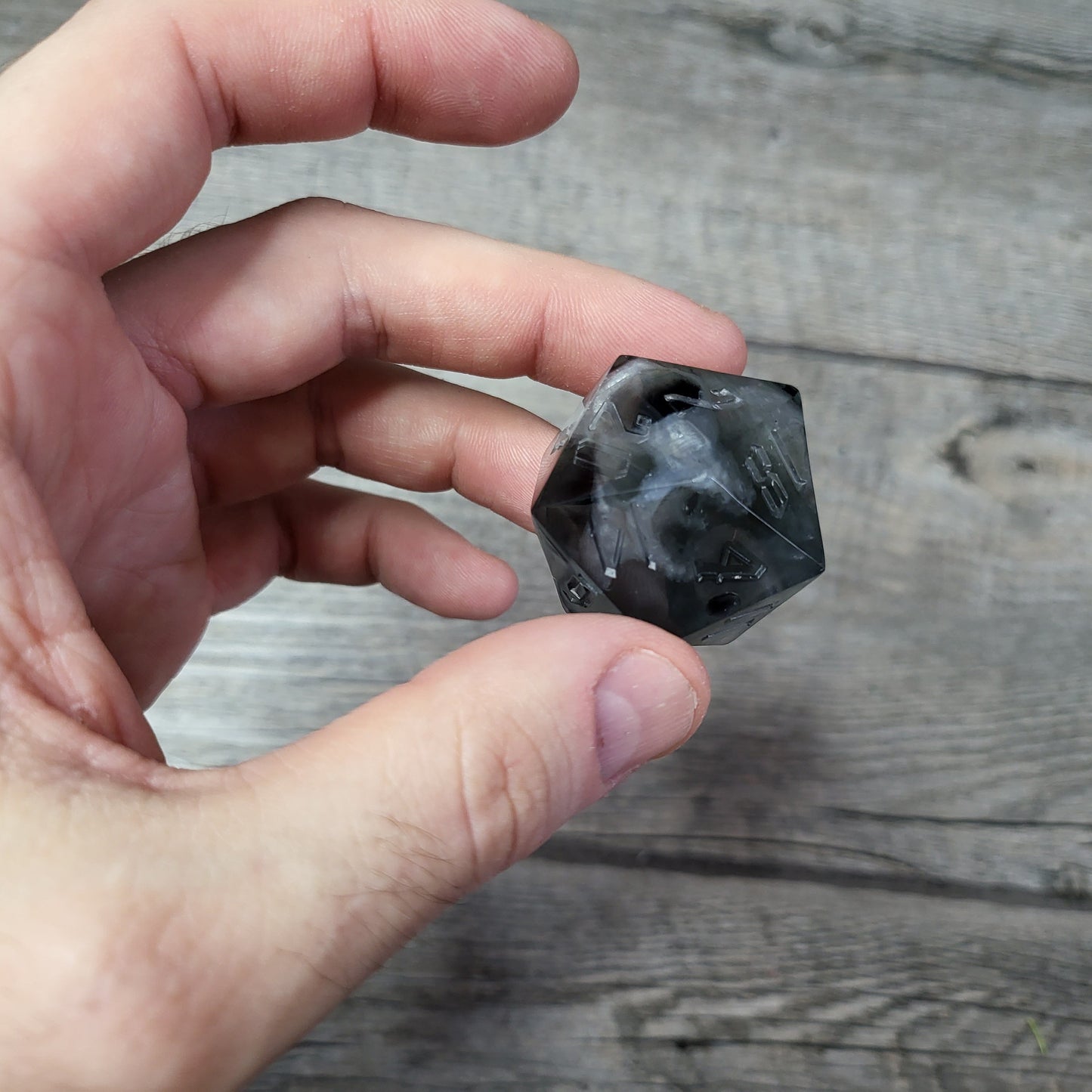 D20 dice in 33 mm format with skull inside for role-playing games for Dungeons and Dragons