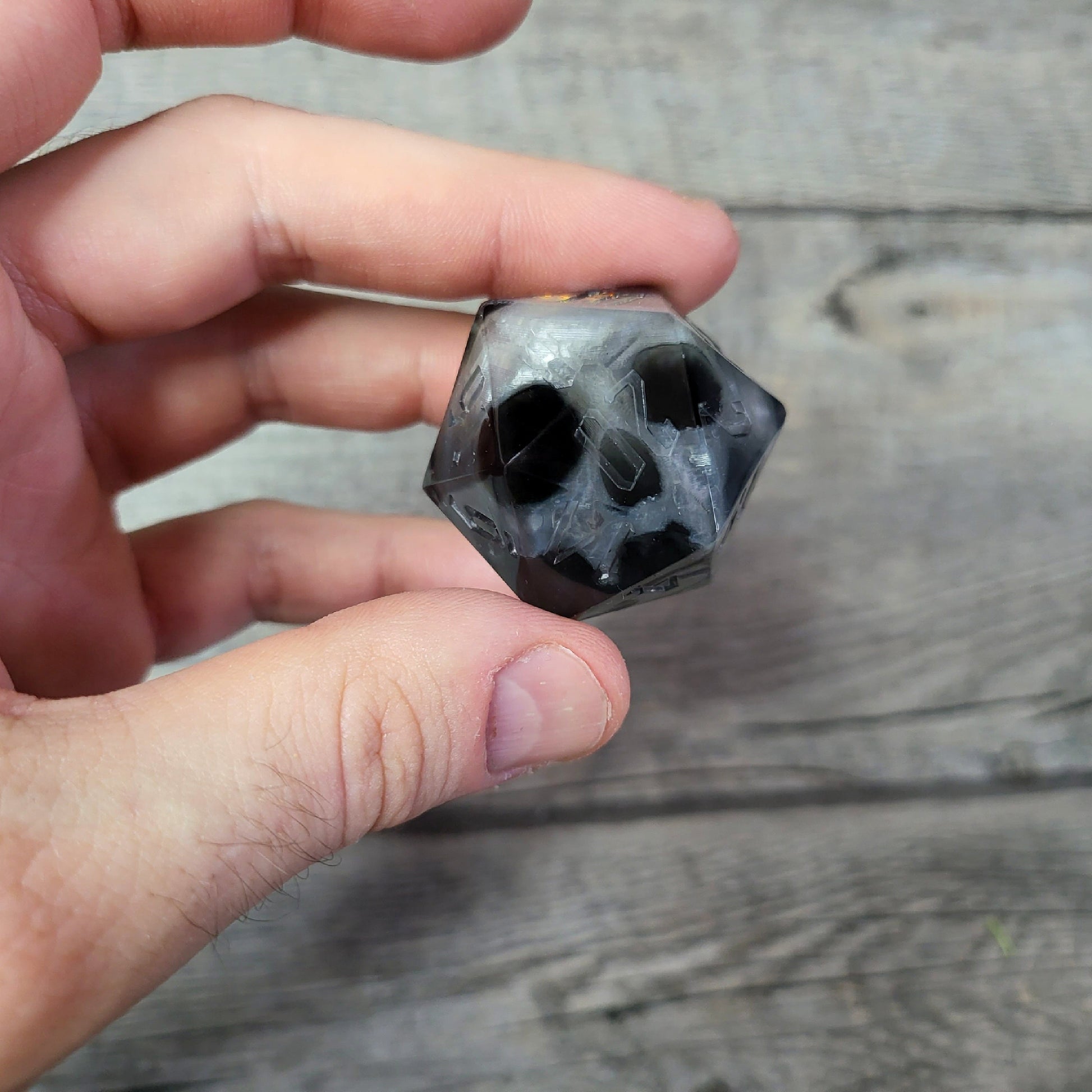 D20 dice in 33 mm format with skull inside for role-playing games for Dungeons and Dragons
