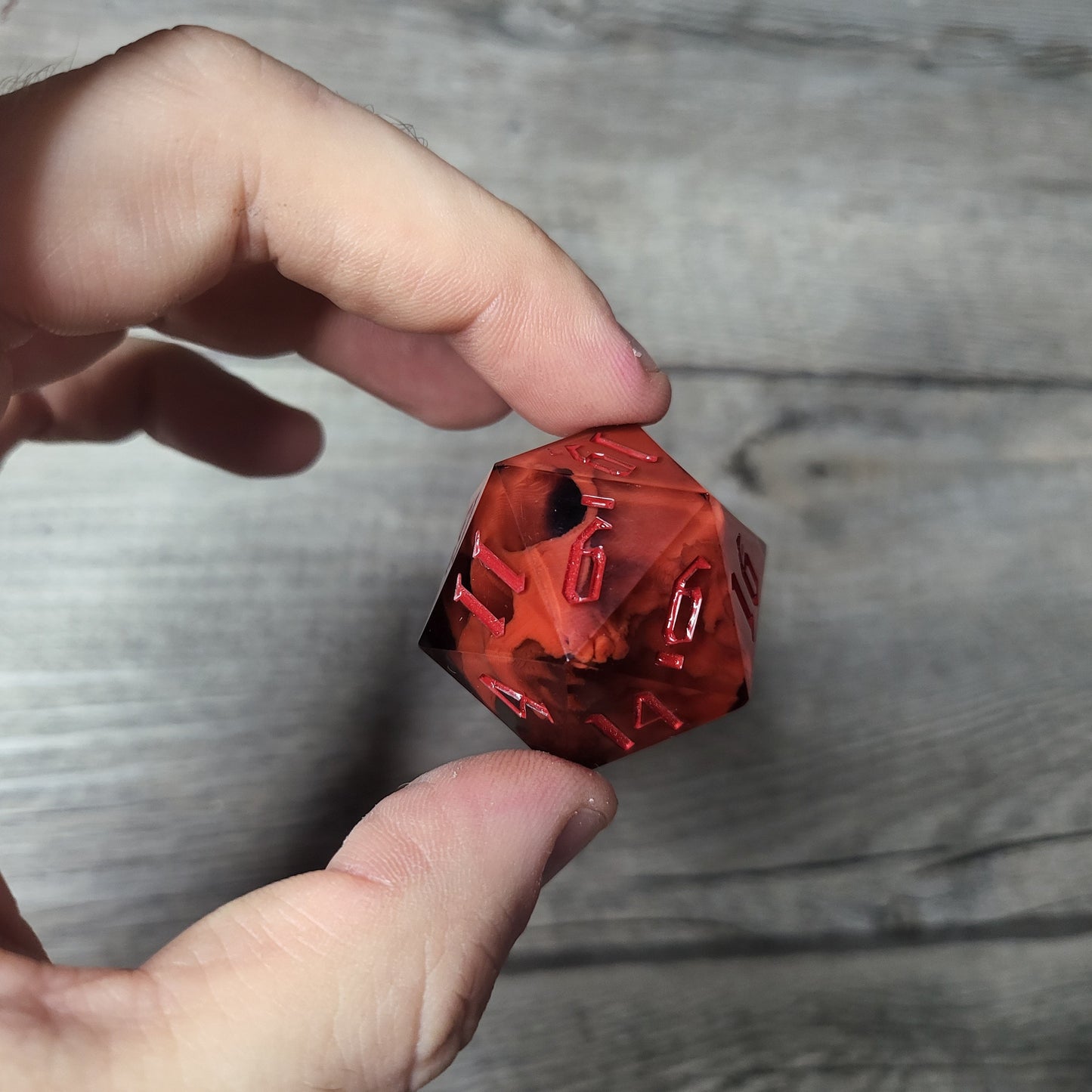 D20 dice in 33 mm format with skull inside for role-playing games for Dungeons and Dragons