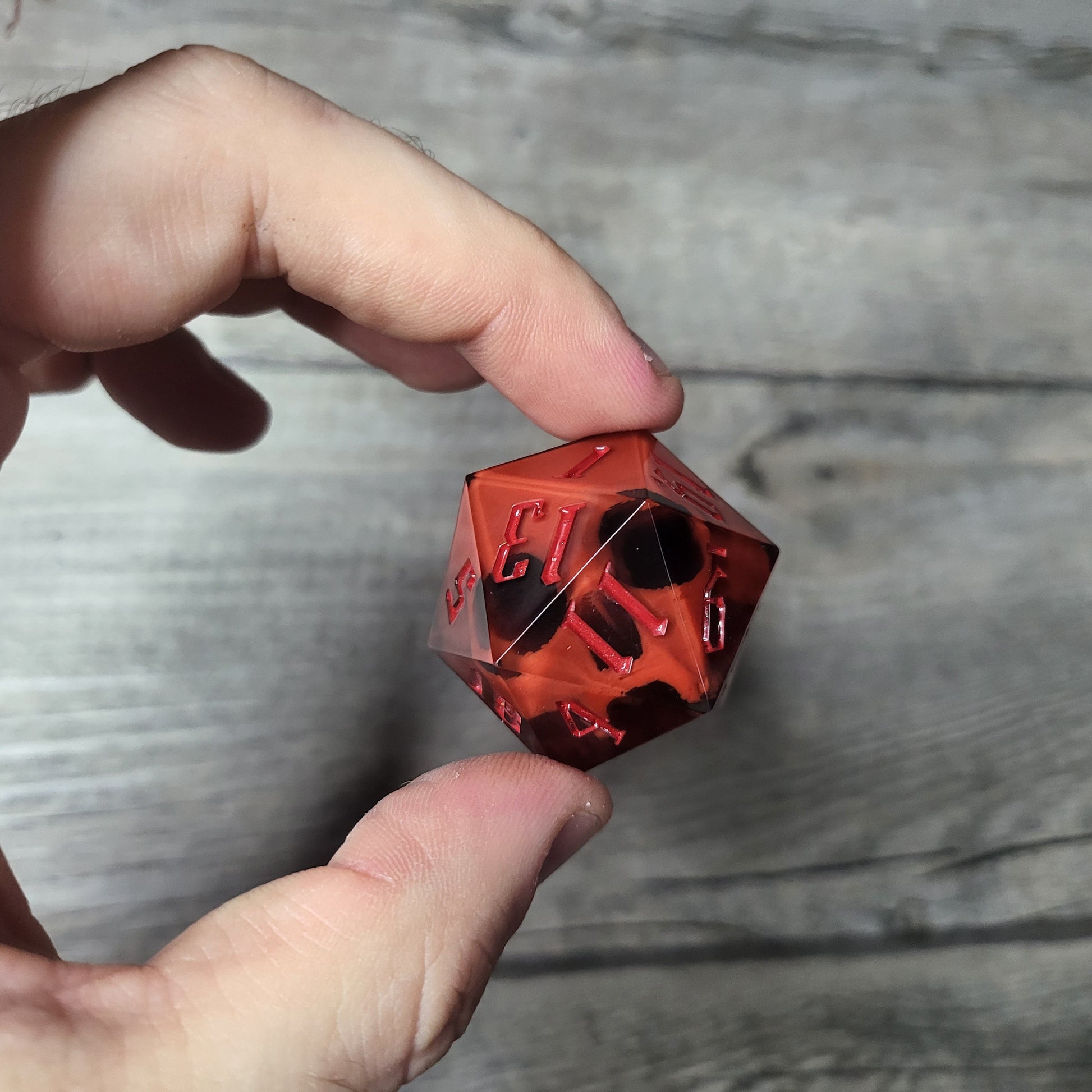 D20 dice in 33 mm format with skull inside for role-playing games for Dungeons and Dragons