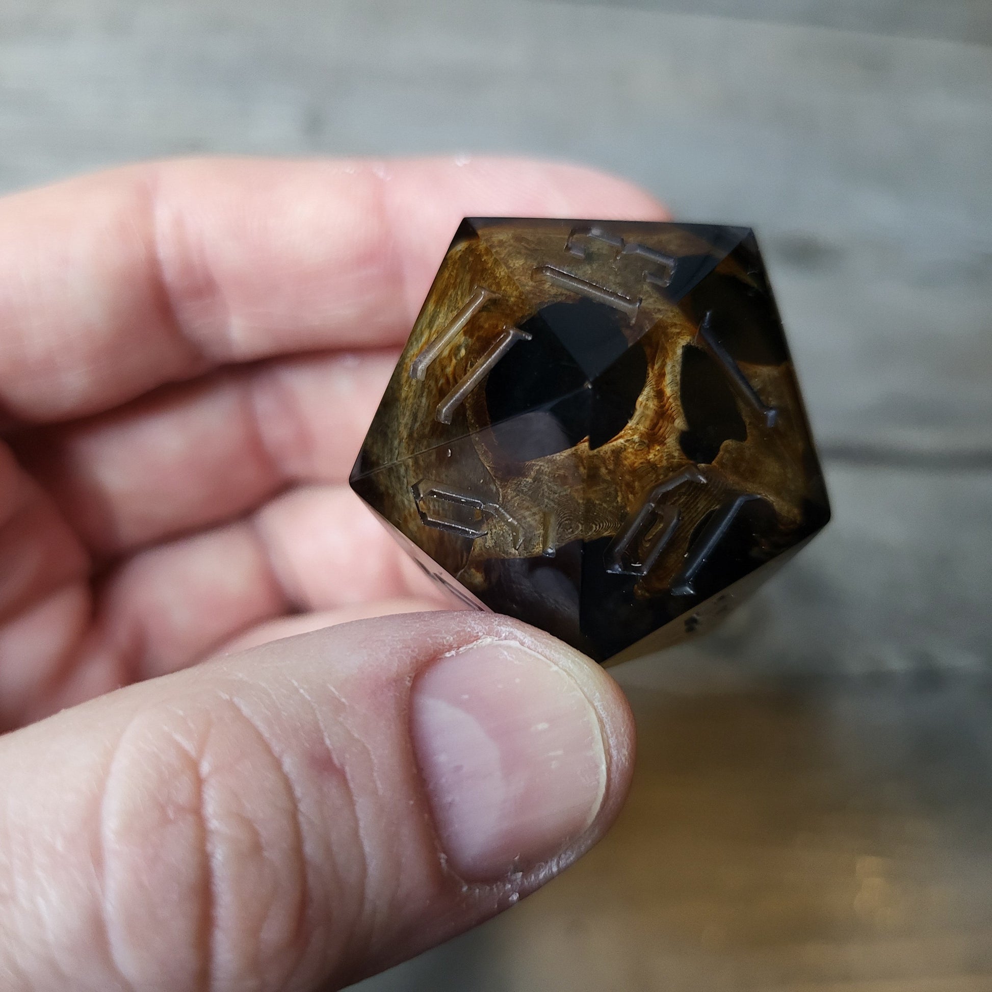 D20 dice in 33 mm format with skull inside for role-playing games for Dungeons and Dragons