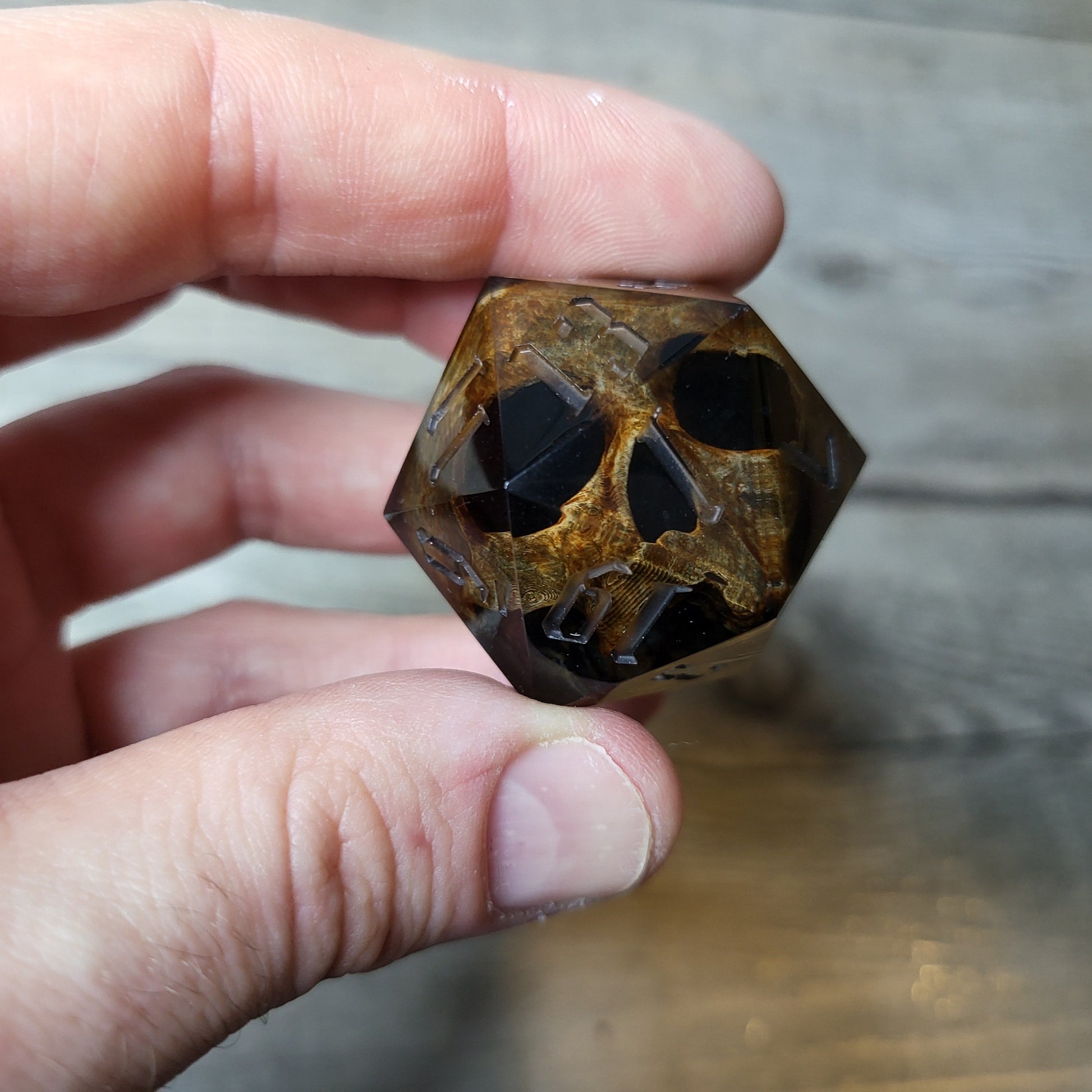 D20 dice in 33 mm format with skull inside for role-playing games for Dungeons and Dragons