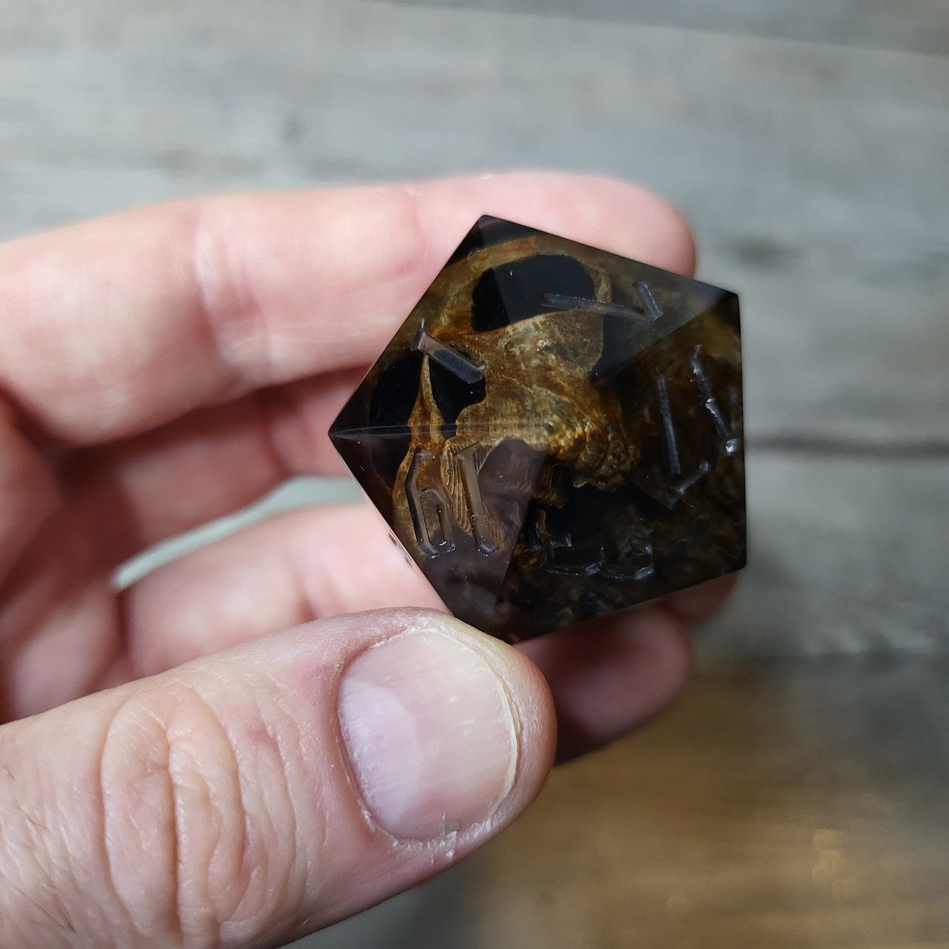D20 dice in 33 mm format with skull inside for role-playing games for Dungeons and Dragons