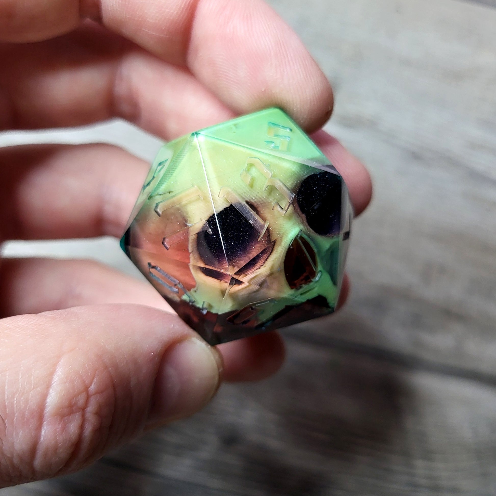 D20 dice in 33 mm format with skull inside for role-playing games for Dungeons and Dragons