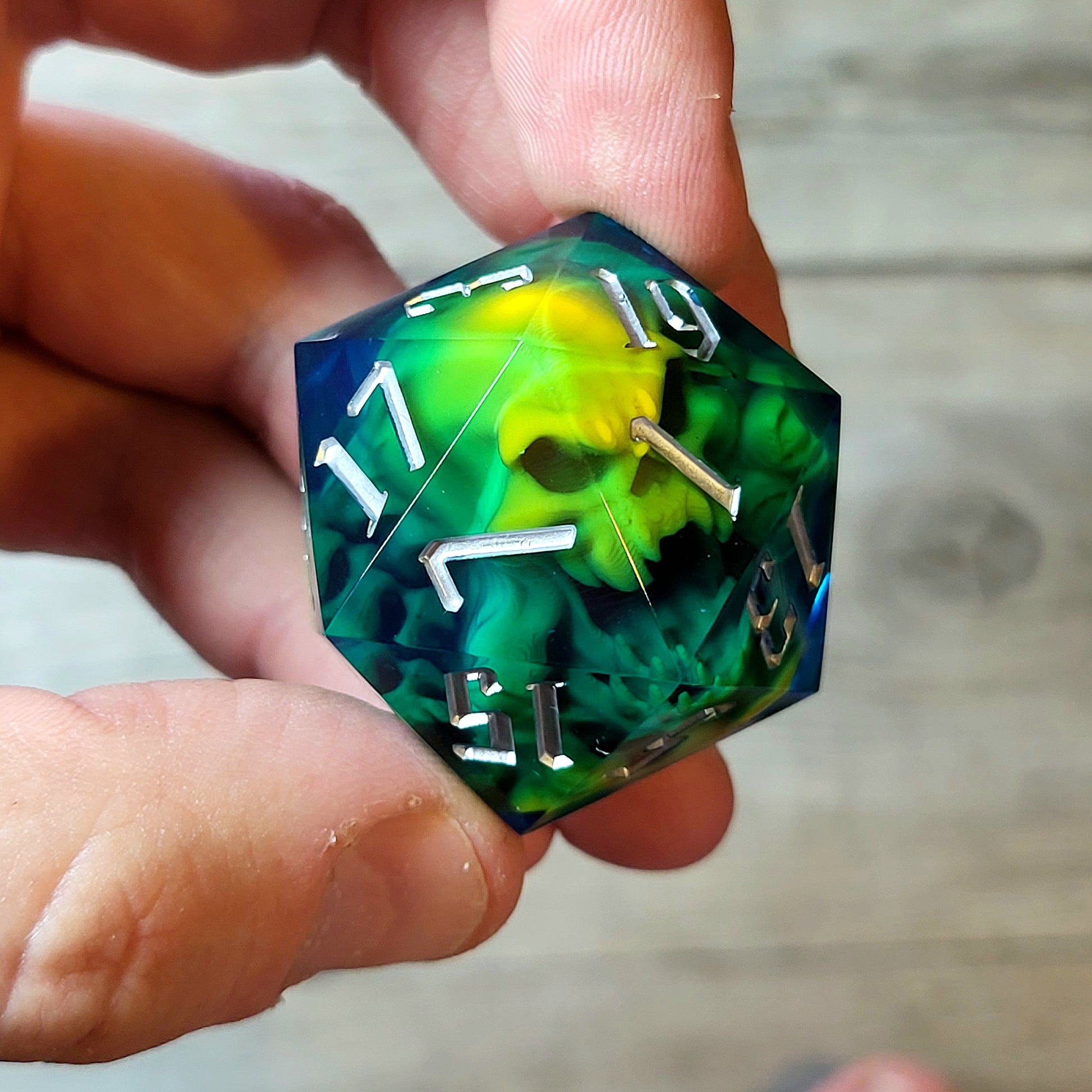 D20 dice in 33 mm format with skull inside for role-playing games for Dungeons and Dragons