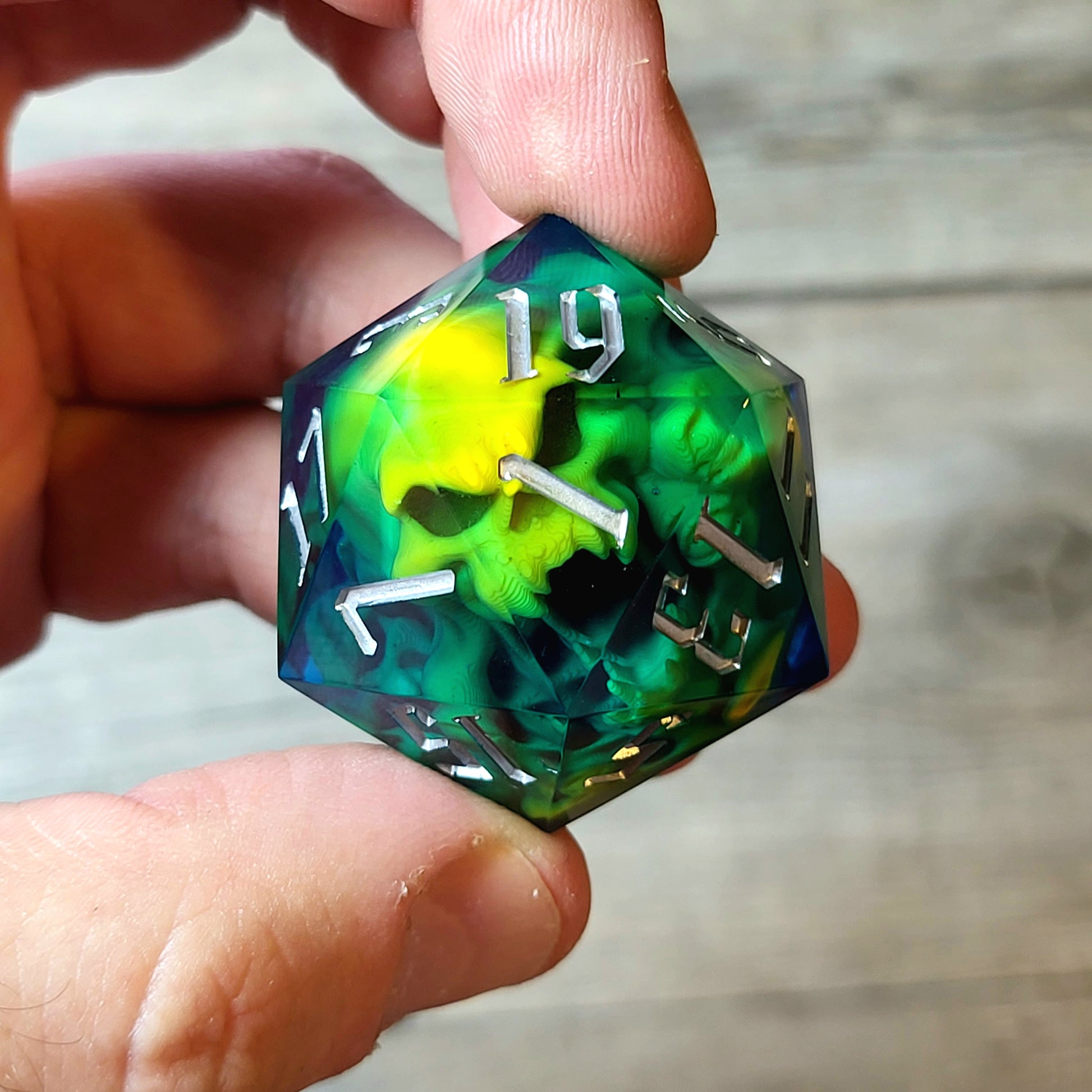 D20 dice in 33 mm format with skull inside for role-playing games for Dungeons and Dragons