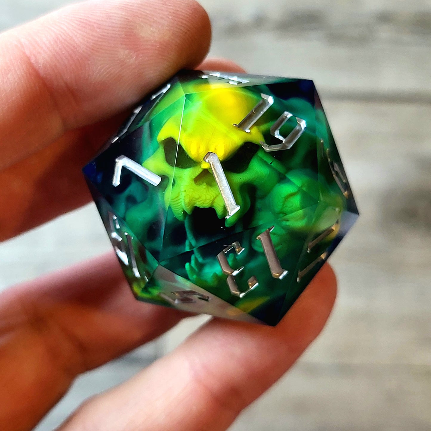 D20 dice in 33 mm format with skull inside for role-playing games for Dungeons and Dragons