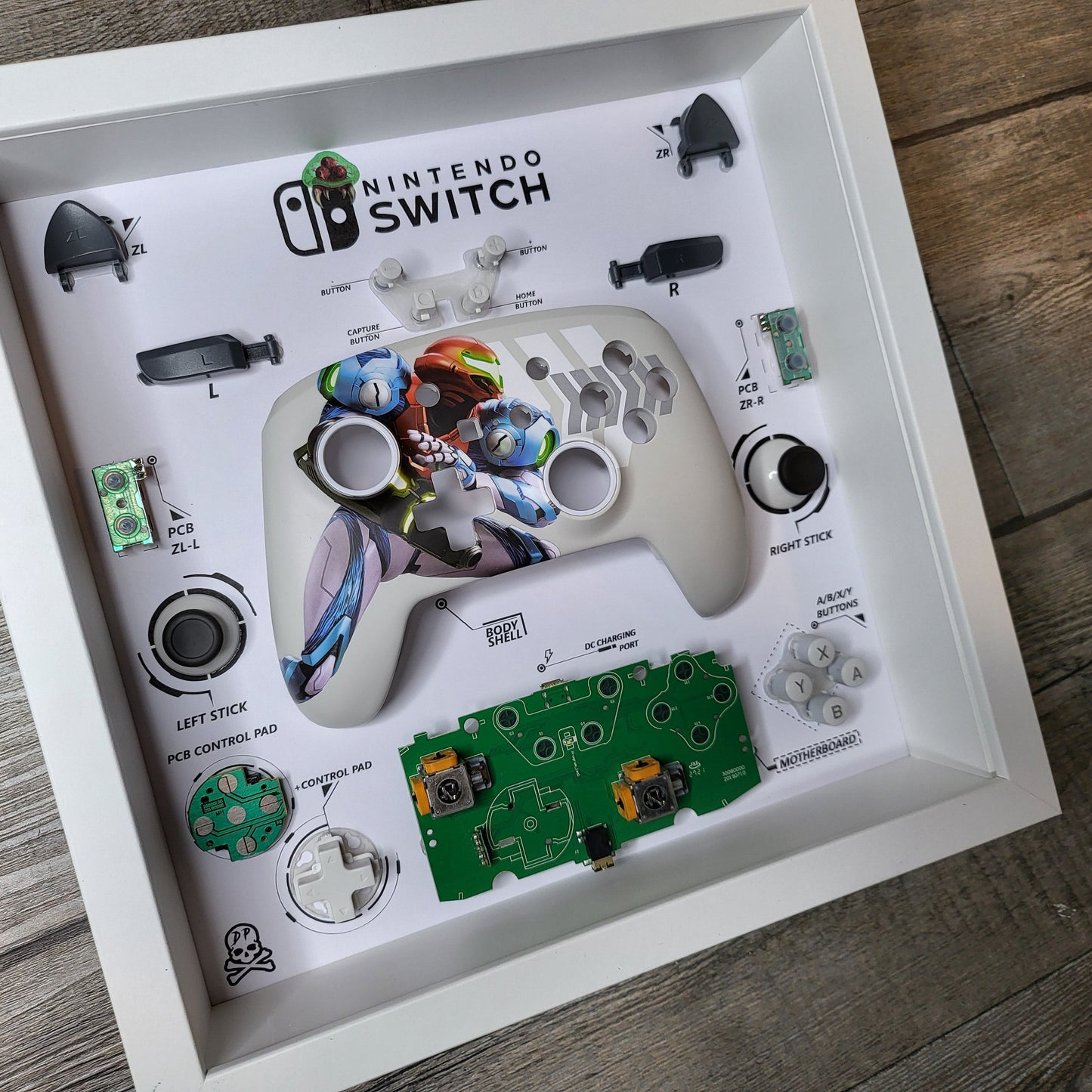 Shadow Box 10x10 with wood frame and polycarbonate glass for wall and Tabletop containing a disassembled controller for Playstation and Nintendo