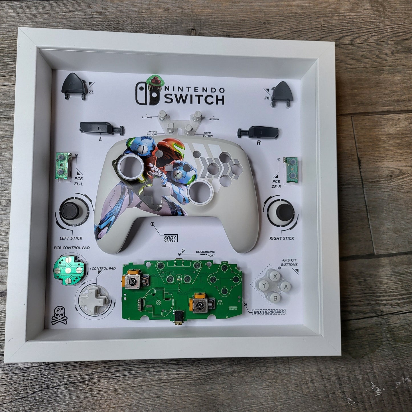 Shadow Box 10x10 with wood frame and polycarbonate glass for wall and Tabletop containing a disassembled controller for Playstation and Nintendo