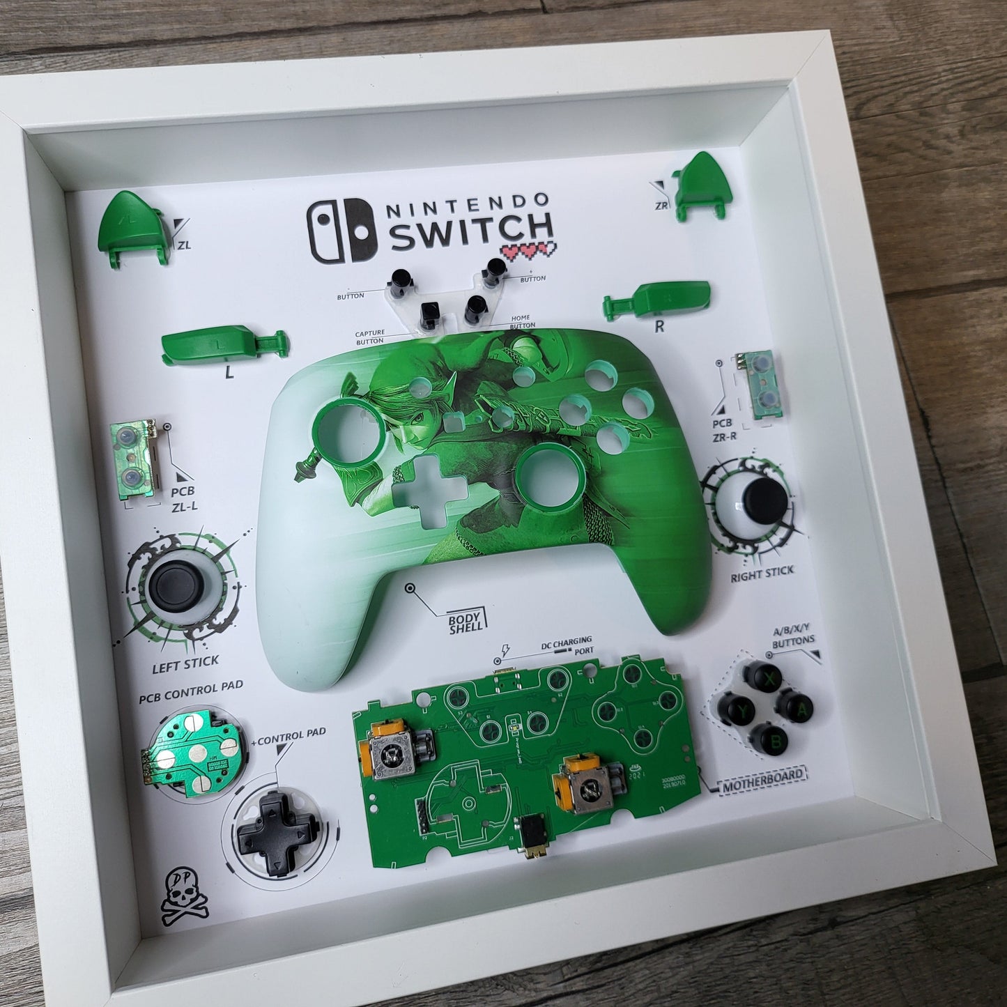 Shadow Box 10x10 with wood frame and polycarbonate glass for wall and Tabletop containing a disassembled controller for Playstation and Nintendo