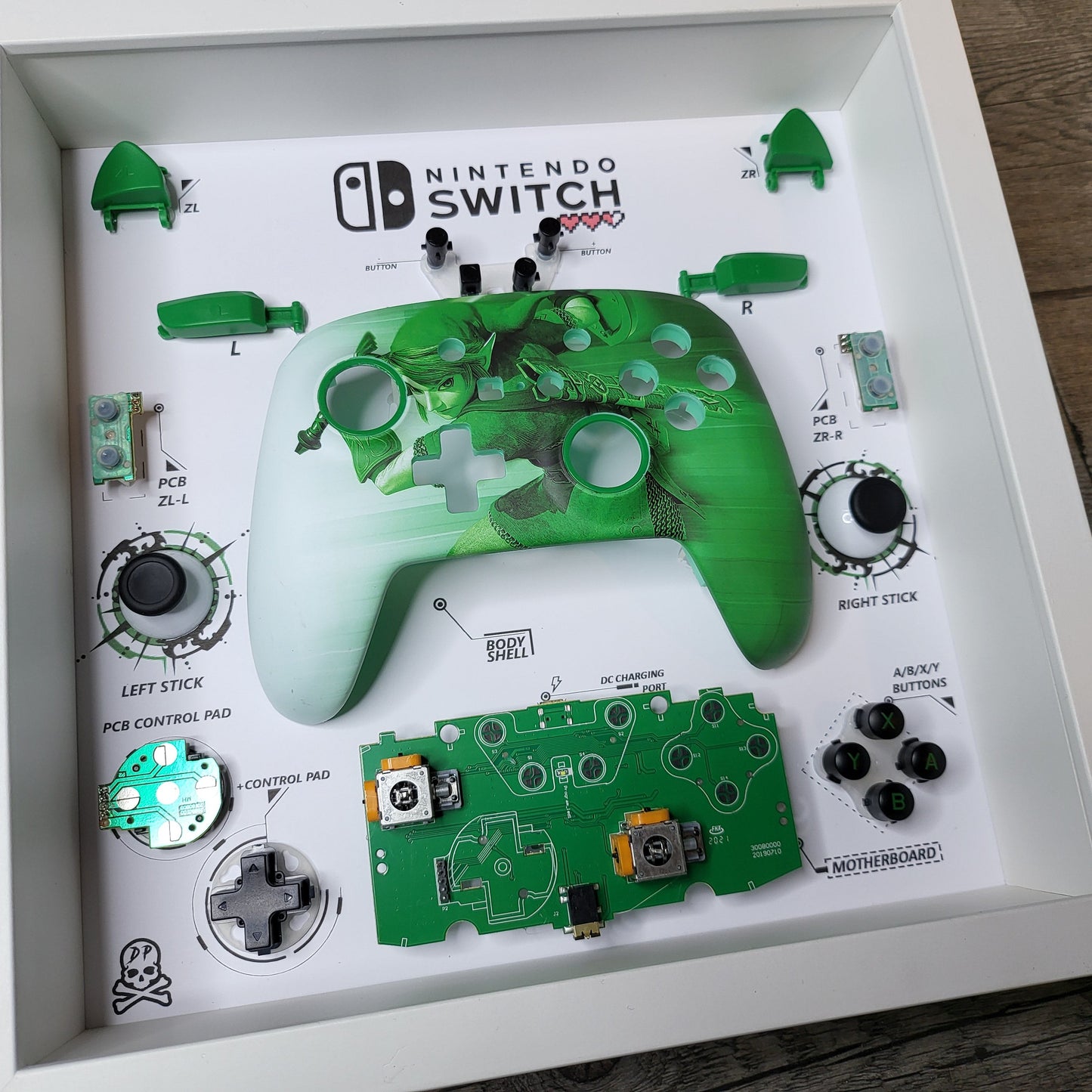 Shadow Box 10x10 with wood frame and polycarbonate glass for wall and Tabletop containing a disassembled controller for Playstation and Nintendo