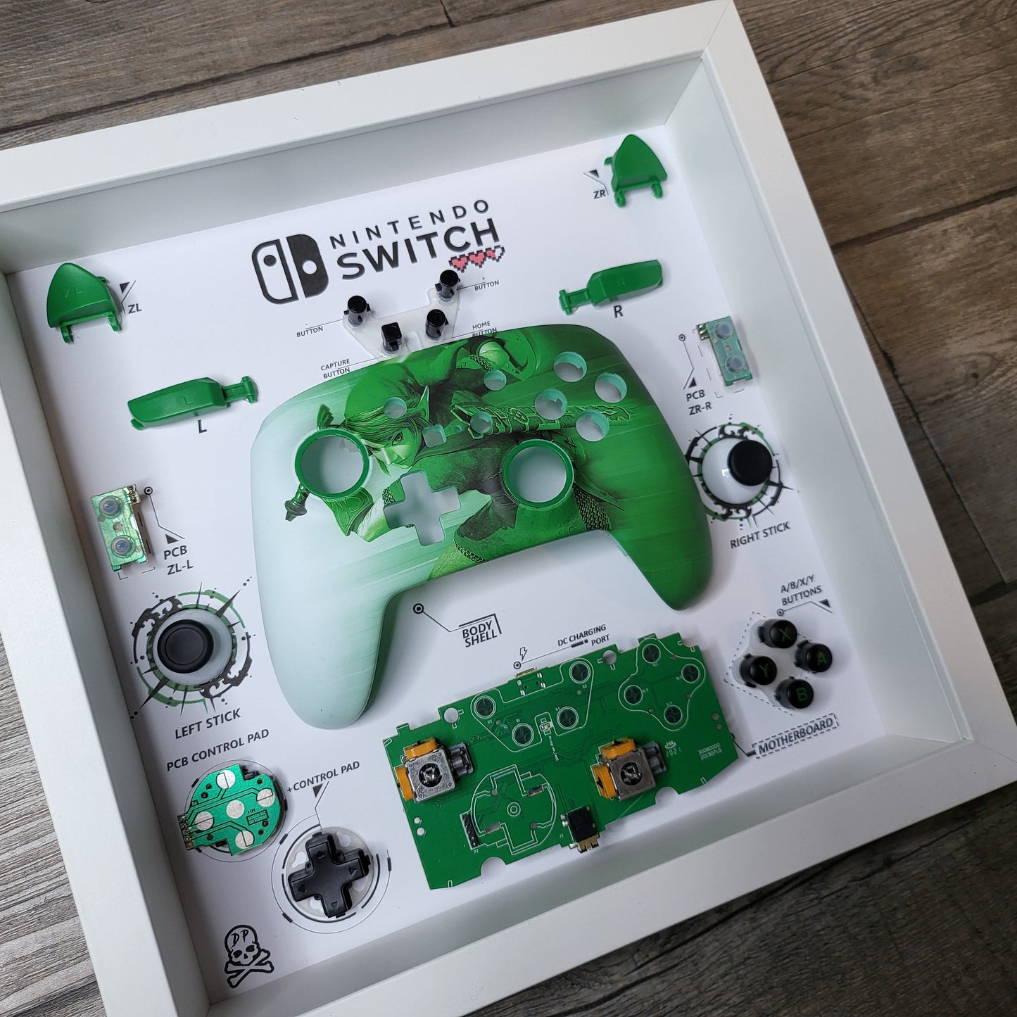 Shadow Box 10x10 with wood frame and polycarbonate glass for wall and Tabletop containing a disassembled controller for Playstation and Nintendo