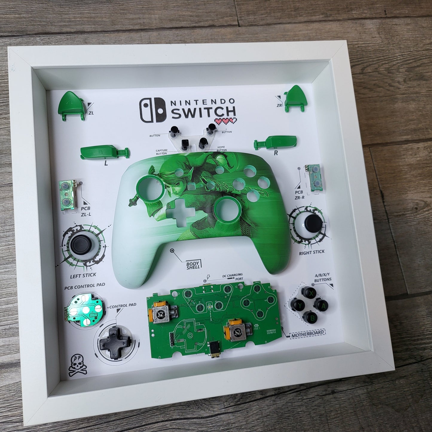 Shadow Box 10x10 with wood frame and polycarbonate glass for wall and Tabletop containing a disassembled controller for Playstation and Nintendo
