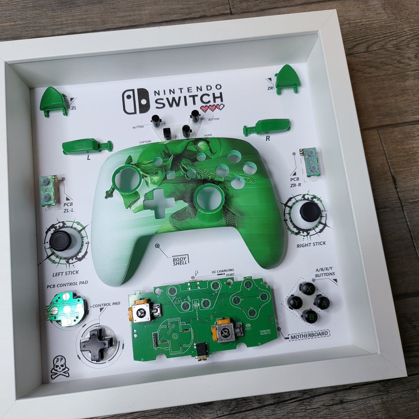 Shadow Box 10x10 with wood frame and polycarbonate glass for wall and Tabletop containing a disassembled controller for Playstation and Nintendo