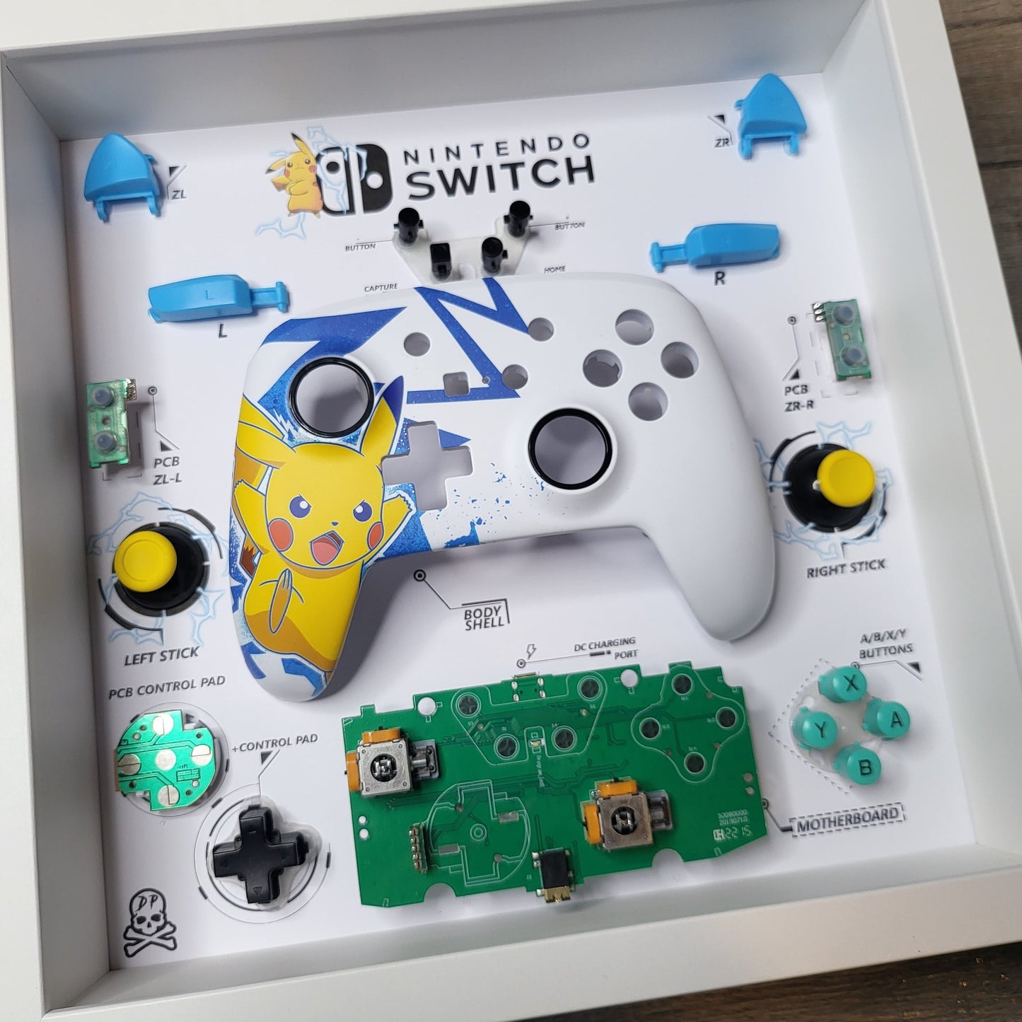 Shadow Box 10x10 with wood frame and polycarbonate glass for wall and Tabletop containing a disassembled controller for Playstation and Nintendo