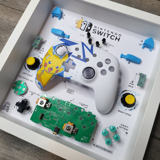 Shadow Box 10x10 with wood frame and polycarbonate glass for wall and Tabletop containing a disassembled controller for Playstation and Nintendo