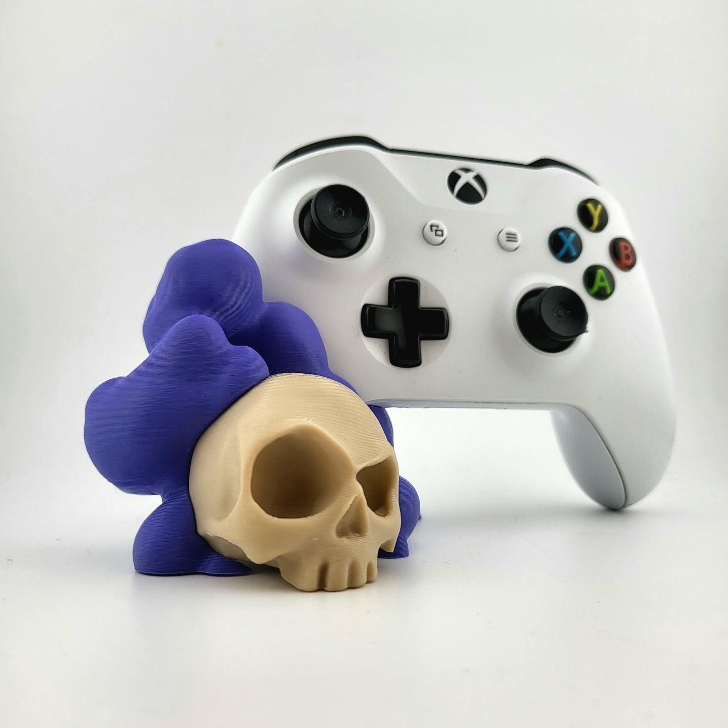 One xbox controller stand featuring a skull design and purple smoke, 3D printed with high-quality PLA.
