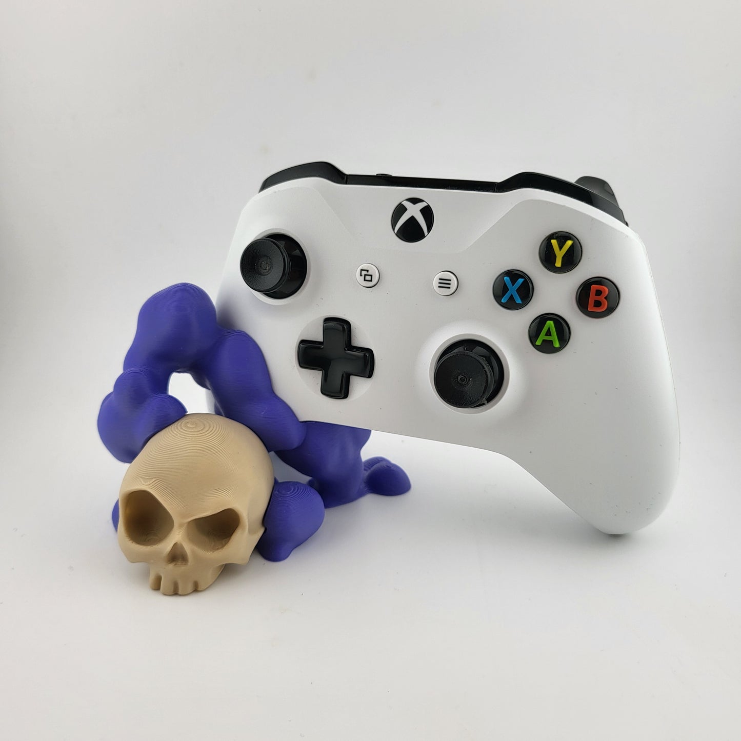 One xbox controller stand featuring a skull design and purple smoke, 3D printed with high-quality PLA.