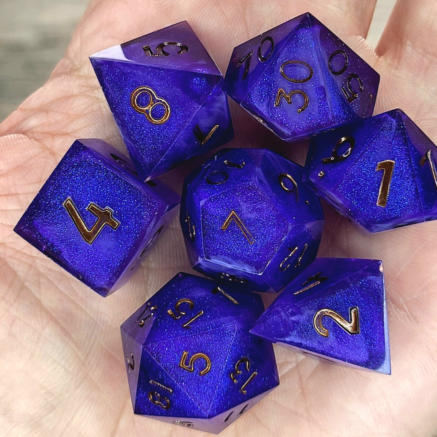 Deep blue and purple shimmering resin DnD dice set with gold numbers