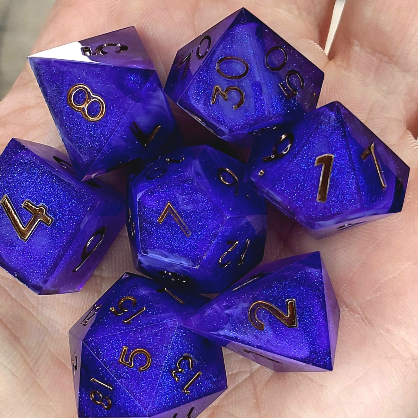 Deep blue and purple shimmering resin DnD dice set with gold numbers