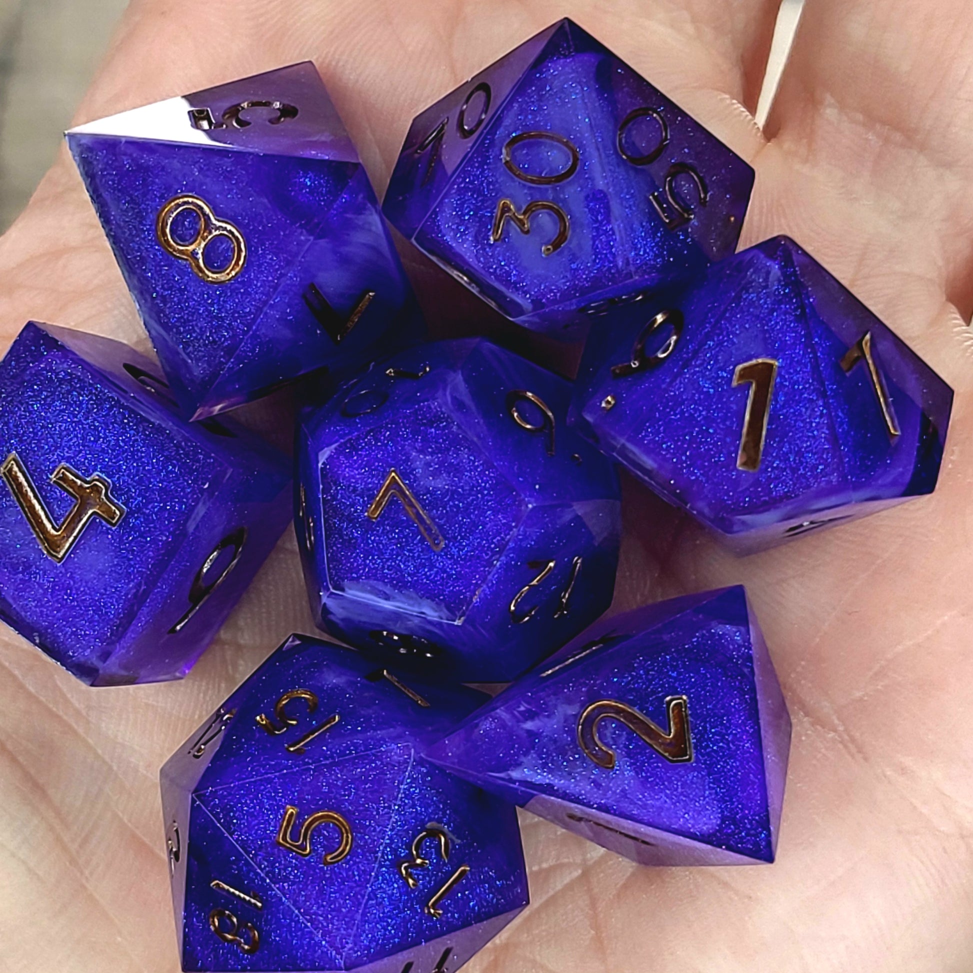 Deep blue and purple shimmering resin DnD dice set with gold numbers
