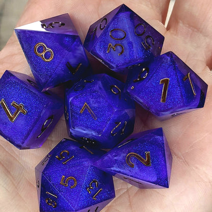 Deep blue and purple shimmering resin DnD dice set with gold numbers