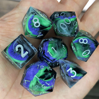 Handcrafted sharp edge resin dice featuring eerie green and purple tentacles suspended in dark transparent resin, surrounded by ghostly white mist and finished with metallic silver numbers