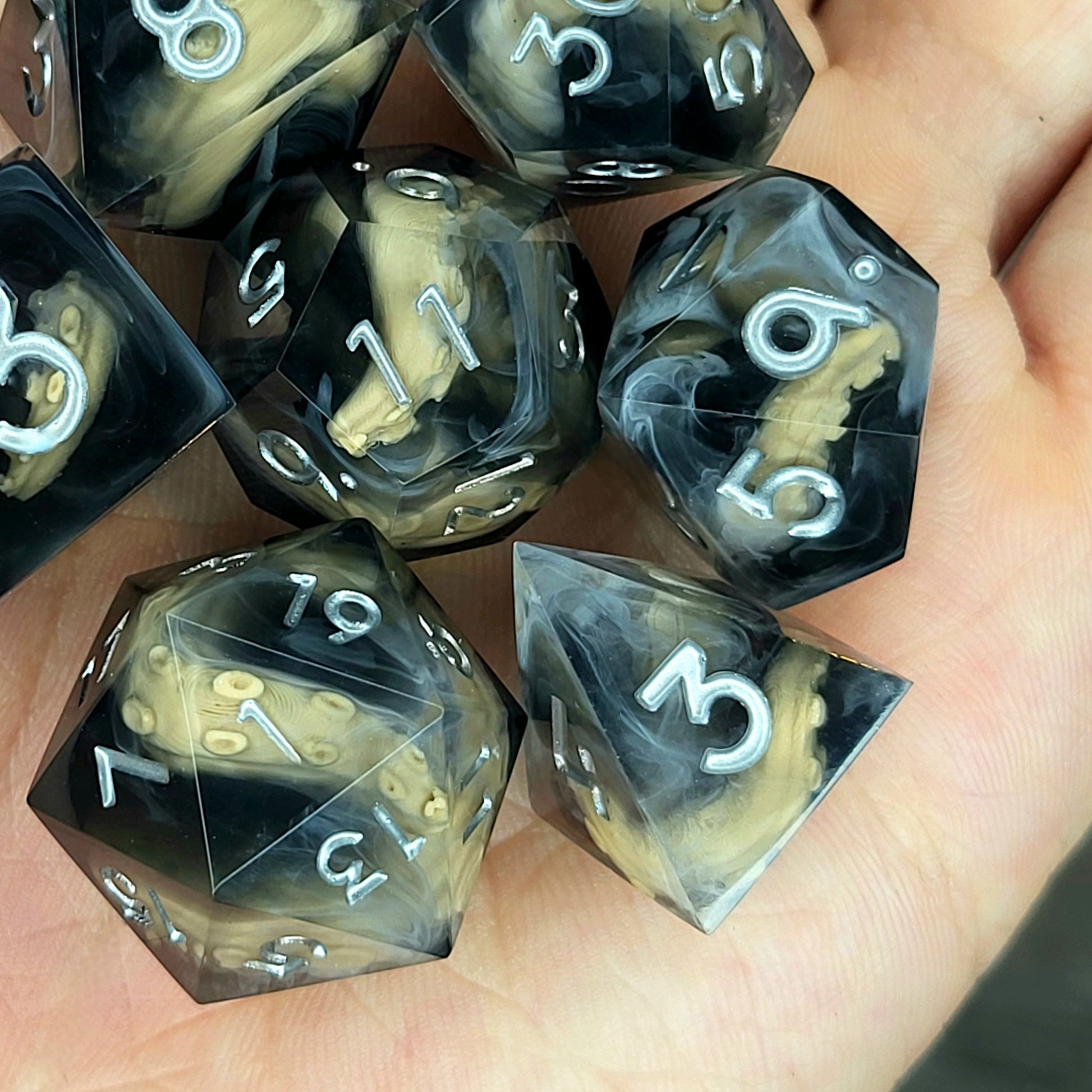 Handcrafted sharp edge resin dice featuring eerie brown tentacles suspended in dark transparent resin, surrounded by ghostly white mist and finished with metallic silver numbers