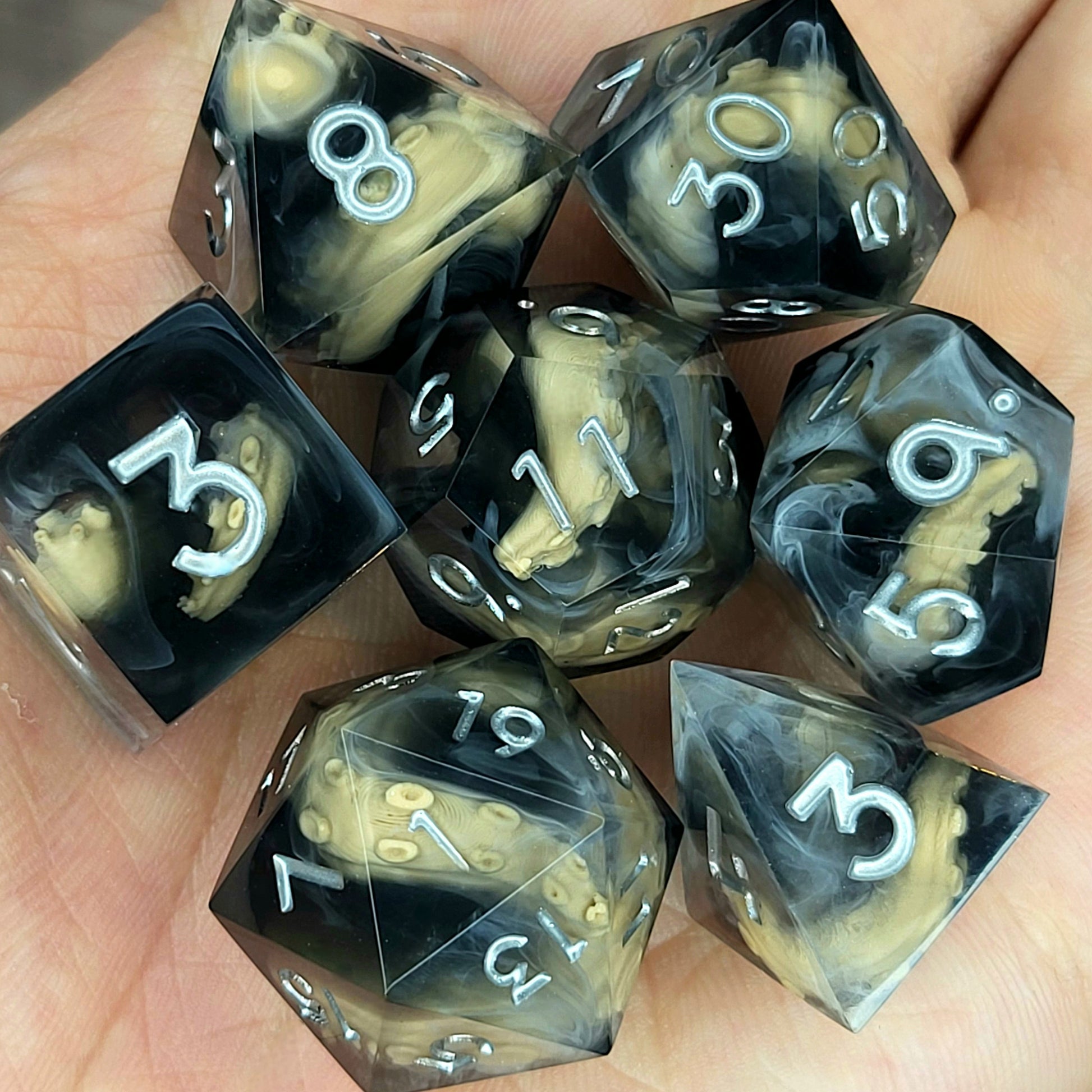 Handcrafted sharp edge resin dice featuring eerie brown tentacles suspended in dark transparent resin, surrounded by ghostly white mist and finished with metallic silver numbers