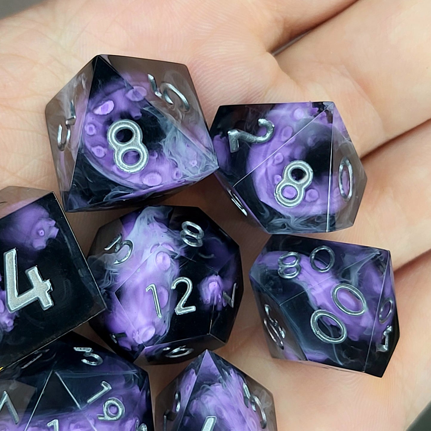 Handcrafted sharp edge resin dice featuring eerie purple tentacles suspended in dark transparent resin, surrounded by ghostly white mist and finished with metallic silver numbers