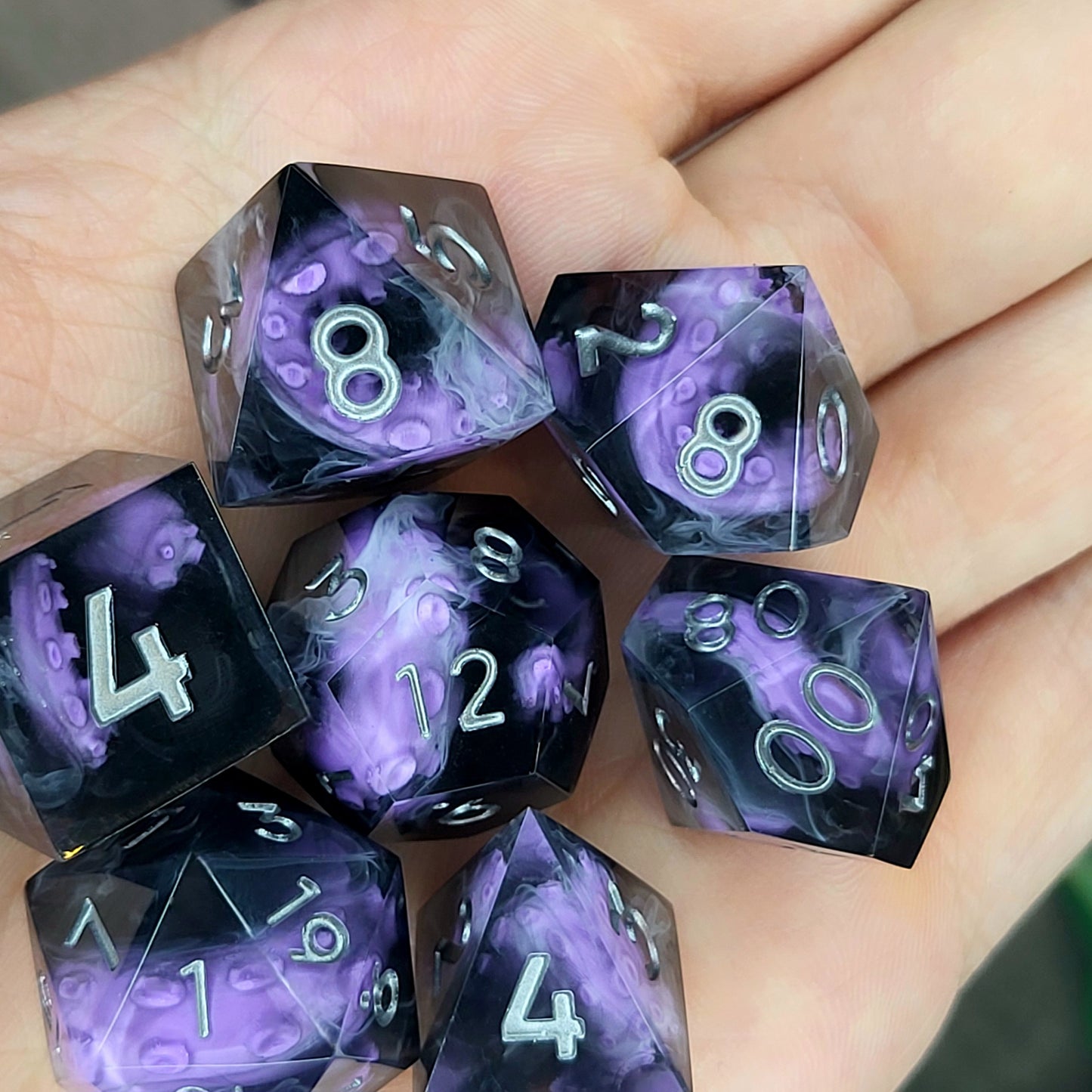 Handcrafted sharp edge resin dice featuring eerie purple tentacles suspended in dark transparent resin, surrounded by ghostly white mist and finished with metallic silver numbers