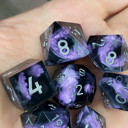 Handcrafted sharp edge resin dice featuring eerie purple tentacles suspended in dark transparent resin, surrounded by ghostly white mist and finished with metallic silver numbers