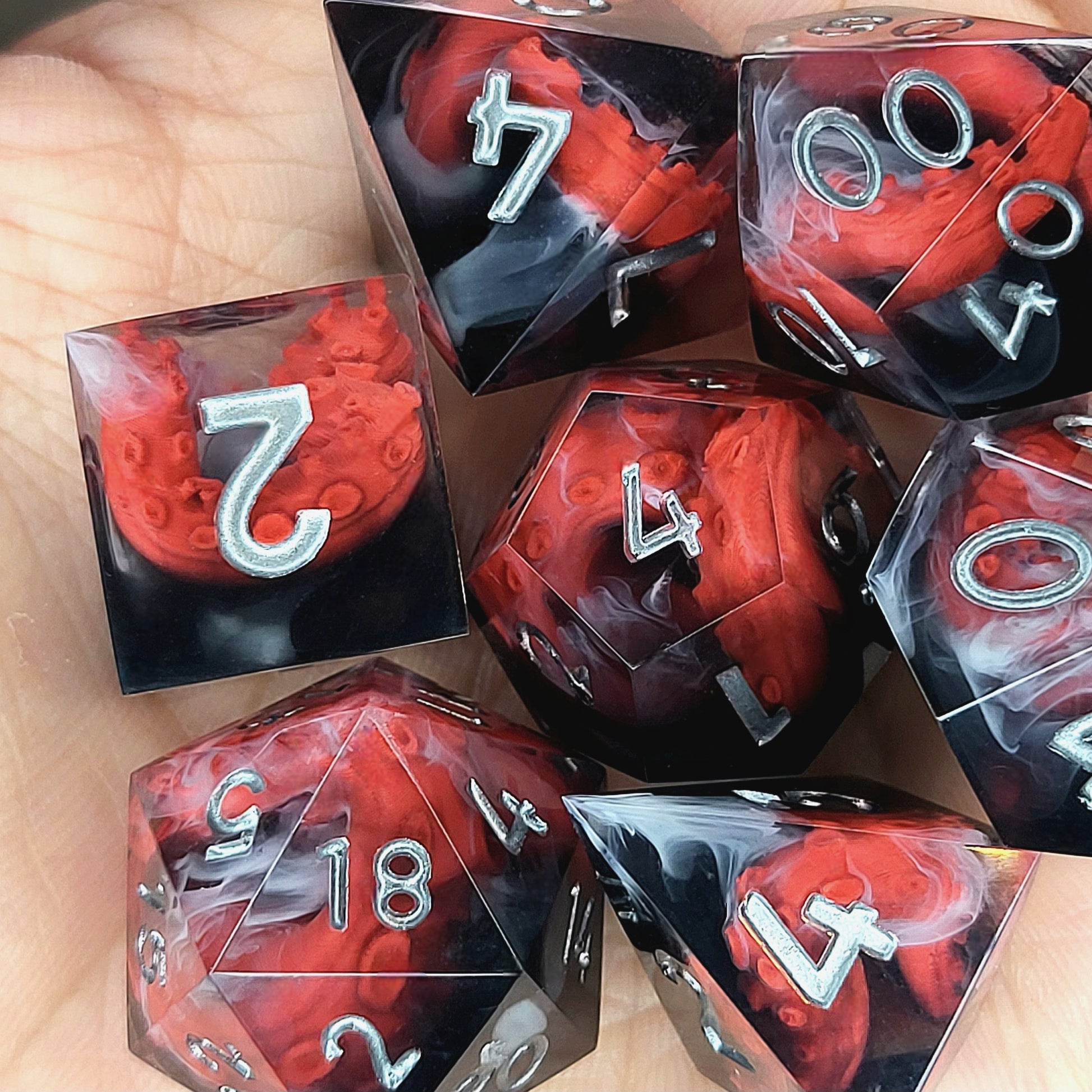 Handcrafted sharp edge resin dice featuring eerie red tentacles suspended in dark transparent resin, surrounded by ghostly white mist and finished with metallic silver numbers