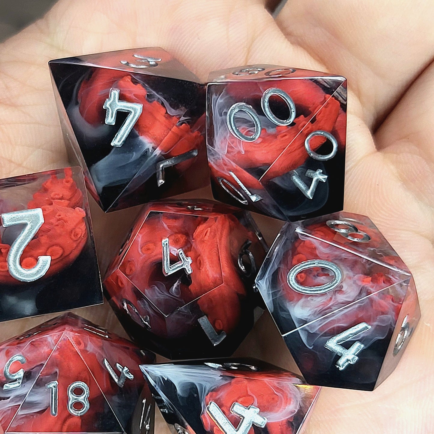 Handcrafted sharp edge resin dice featuring eerie red tentacles suspended in dark transparent resin, surrounded by ghostly white mist and finished with metallic silver numbers