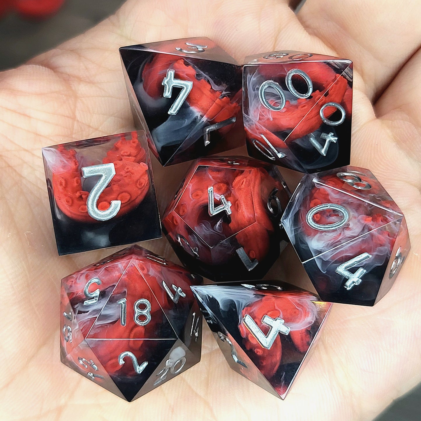 Handcrafted sharp edge resin dice featuring eerie red tentacles suspended in dark transparent resin, surrounded by ghostly white mist and finished with metallic silver numbers