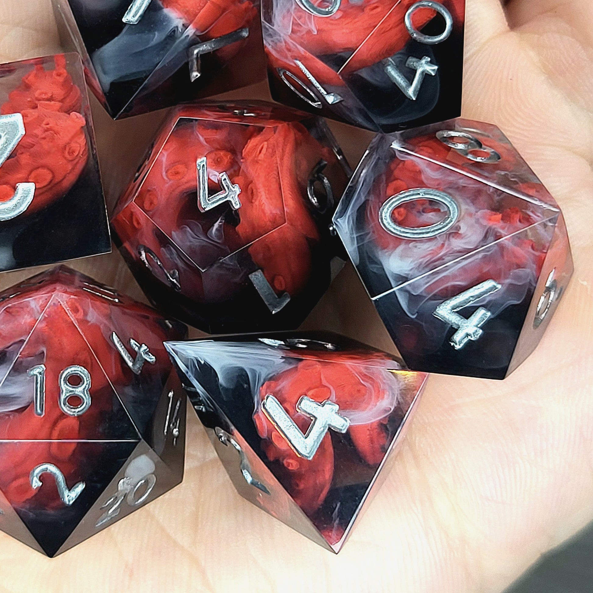 Handcrafted sharp edge resin dice featuring eerie red tentacles suspended in dark transparent resin, surrounded by ghostly white mist and finished with metallic silver numbers
