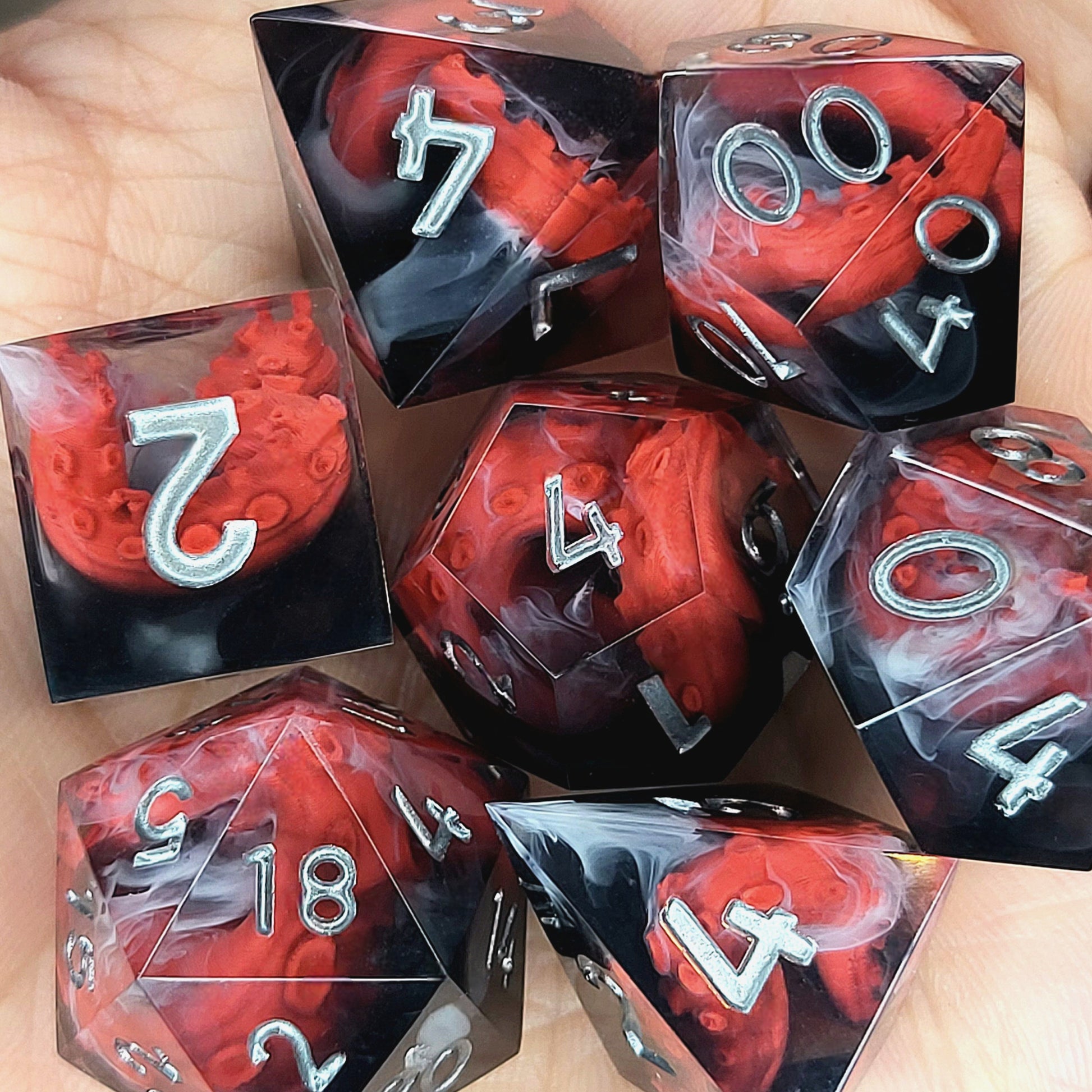 Handcrafted sharp edge resin dice featuring eerie red tentacles suspended in dark transparent resin, surrounded by ghostly white mist and finished with metallic silver numbers