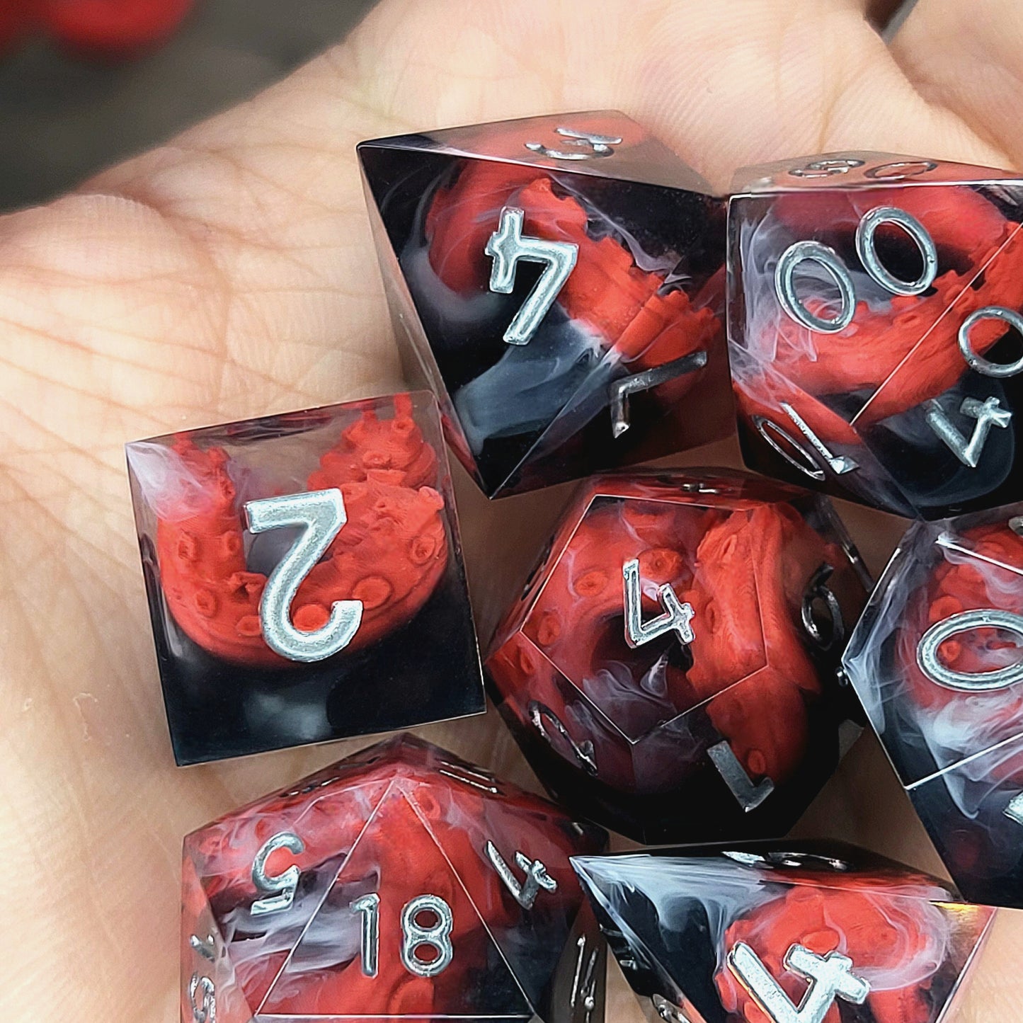 Handcrafted sharp edge resin dice featuring eerie red tentacles suspended in dark transparent resin, surrounded by ghostly white mist and finished with metallic silver numbers