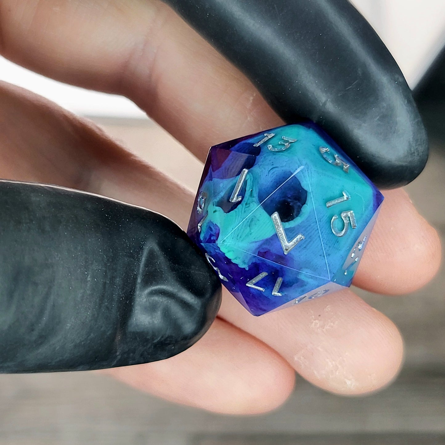 This is a single set of one D20 DnD die with a green skull inside , purple resin and silver numbers