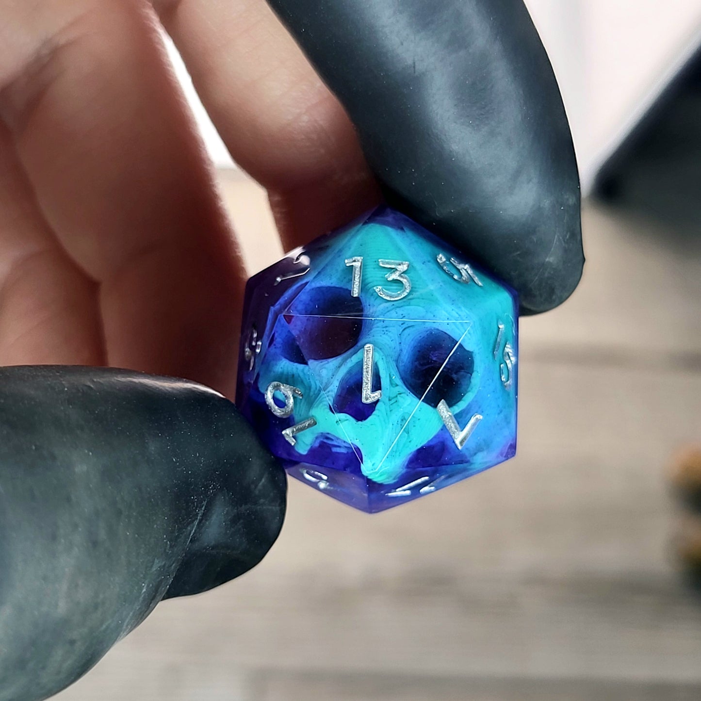 This is a single set of one D20 DnD die with a green skull inside , purple resin and silver numbers