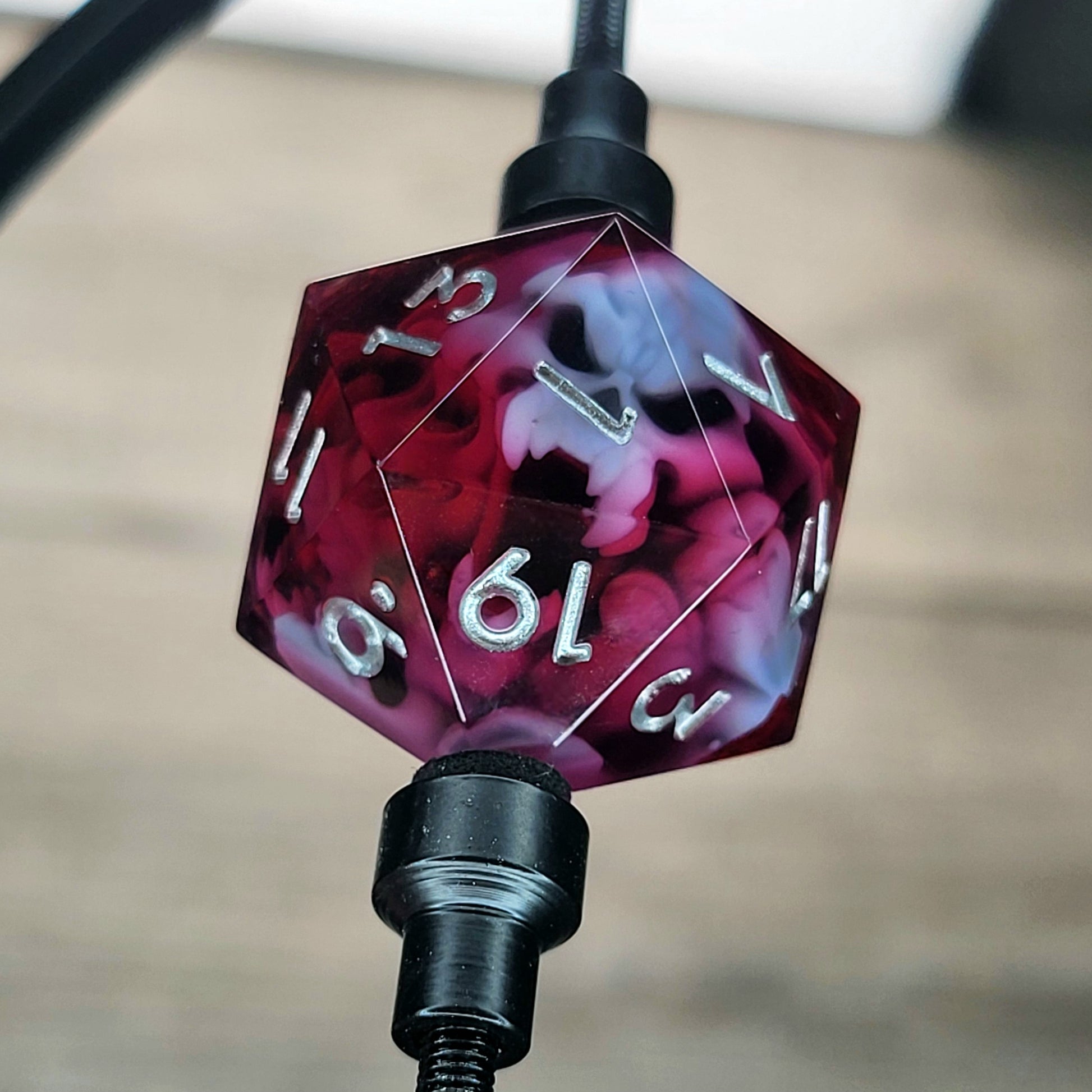 This is a single set of one D20 DnD die with a white spirit inside , red resin and silver numbers