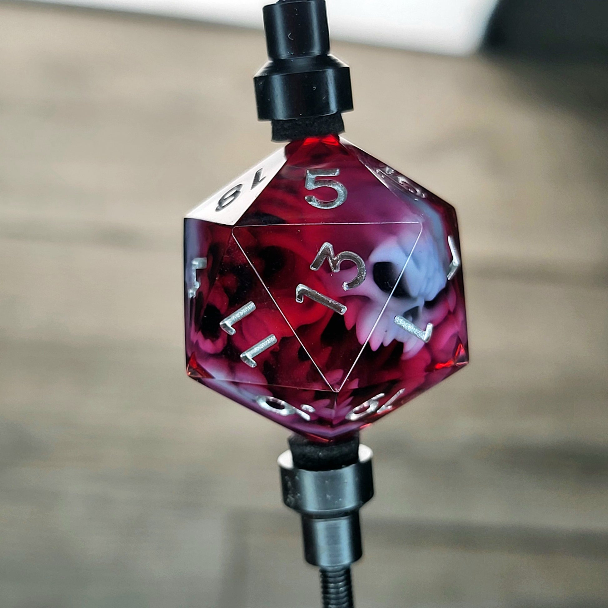 This is a single set of one D20 DnD die with a white spirit inside , red resin and silver numbers
