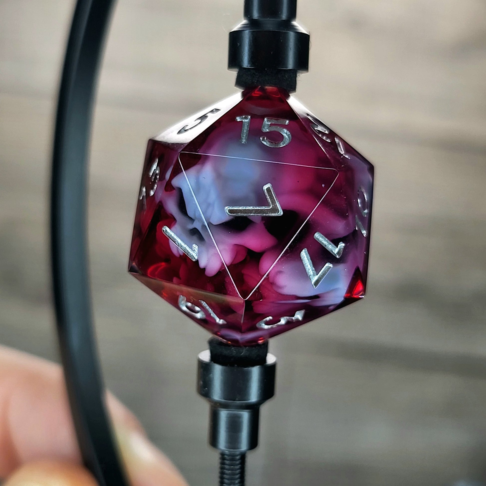 This is a single set of one D20 DnD die with a white spirit inside , red resin and silver numbers