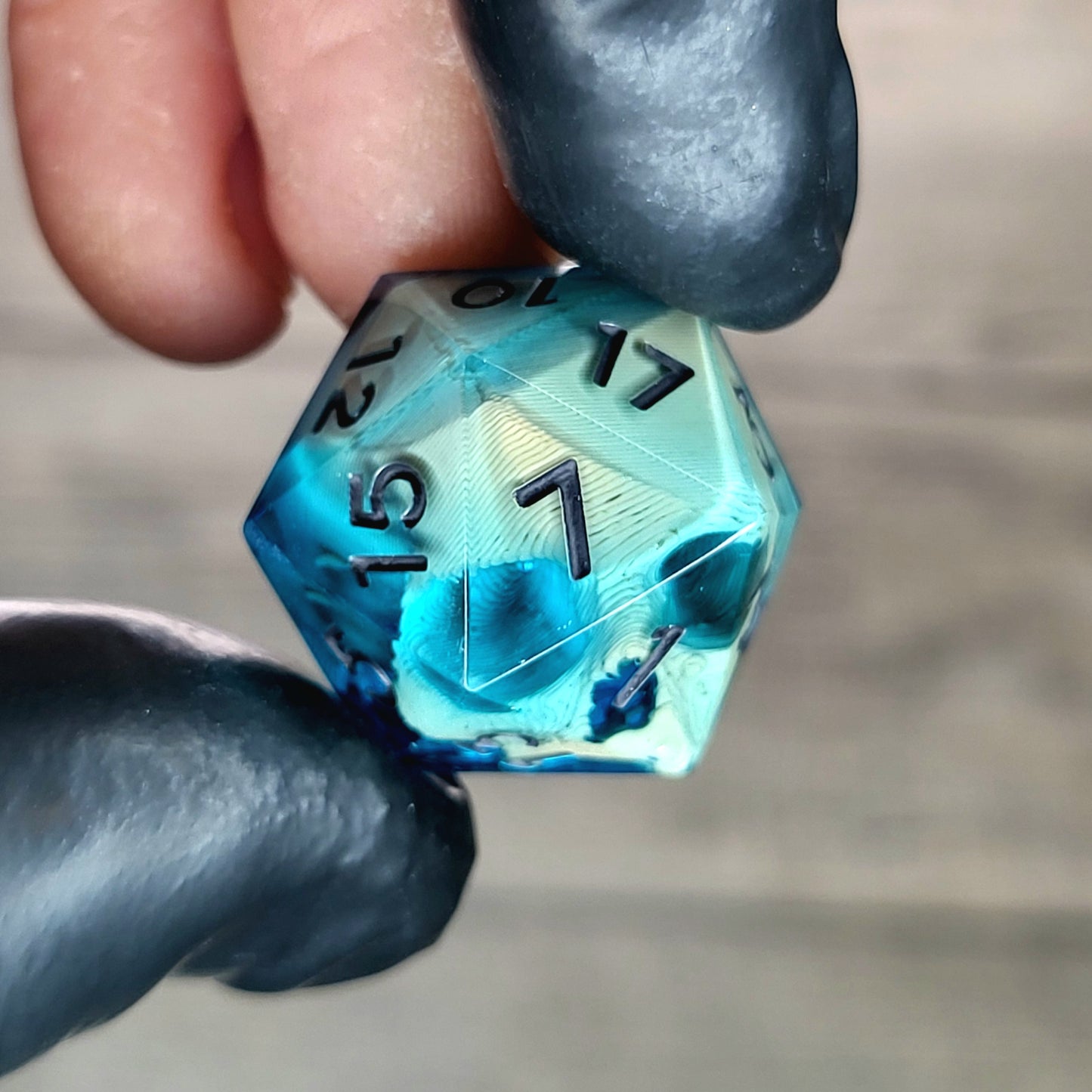 This is a single set of one D20 die with a light brown skull inside , blue resin and black numbers for play dnd dungeons and dragons