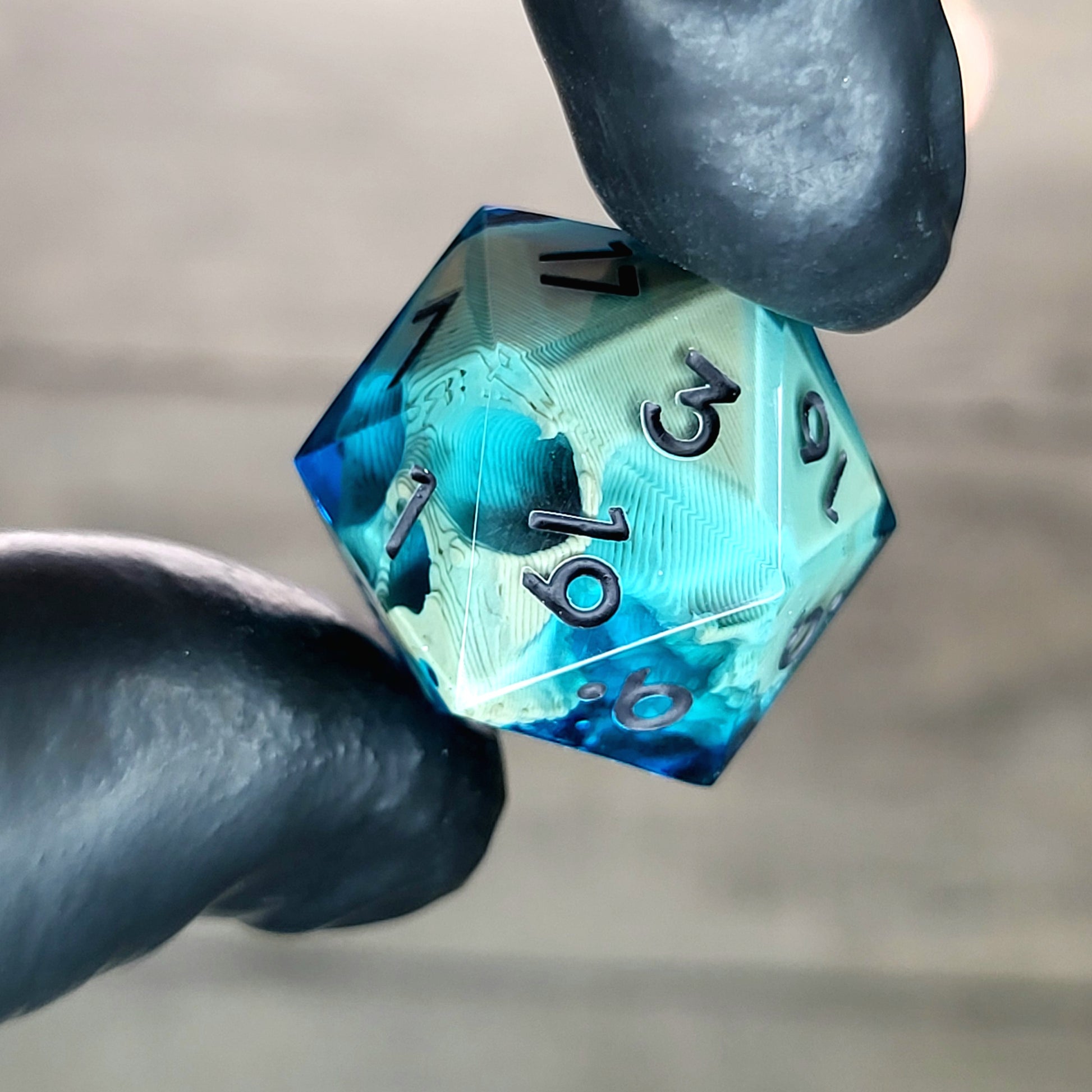 This is a single set of one D20 die with a light brown skull inside , blue resin and black numbers for play dnd dungeons and dragons