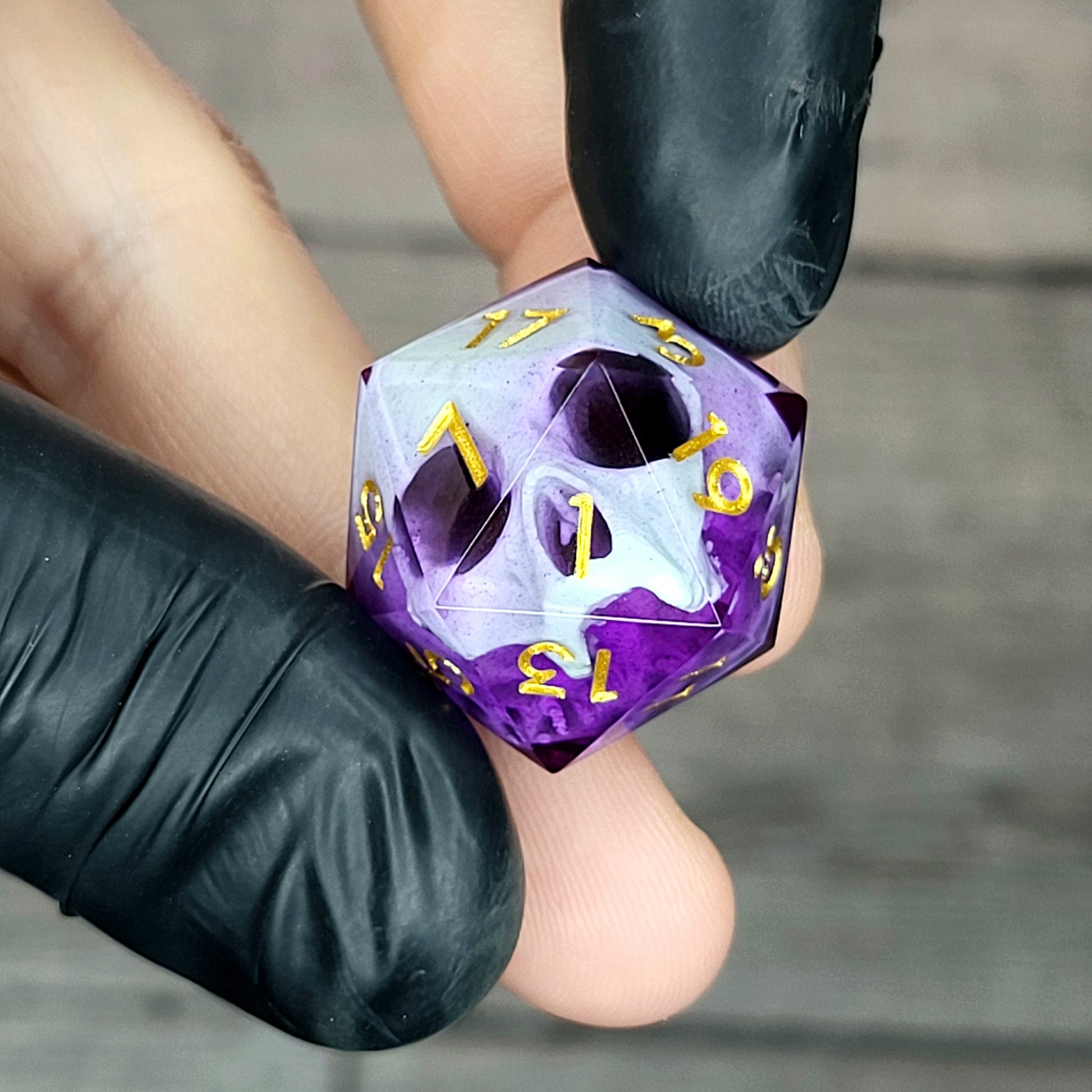 This is a single set of one D20 DnD die with a light green skull inside , purple resin and gold numbers