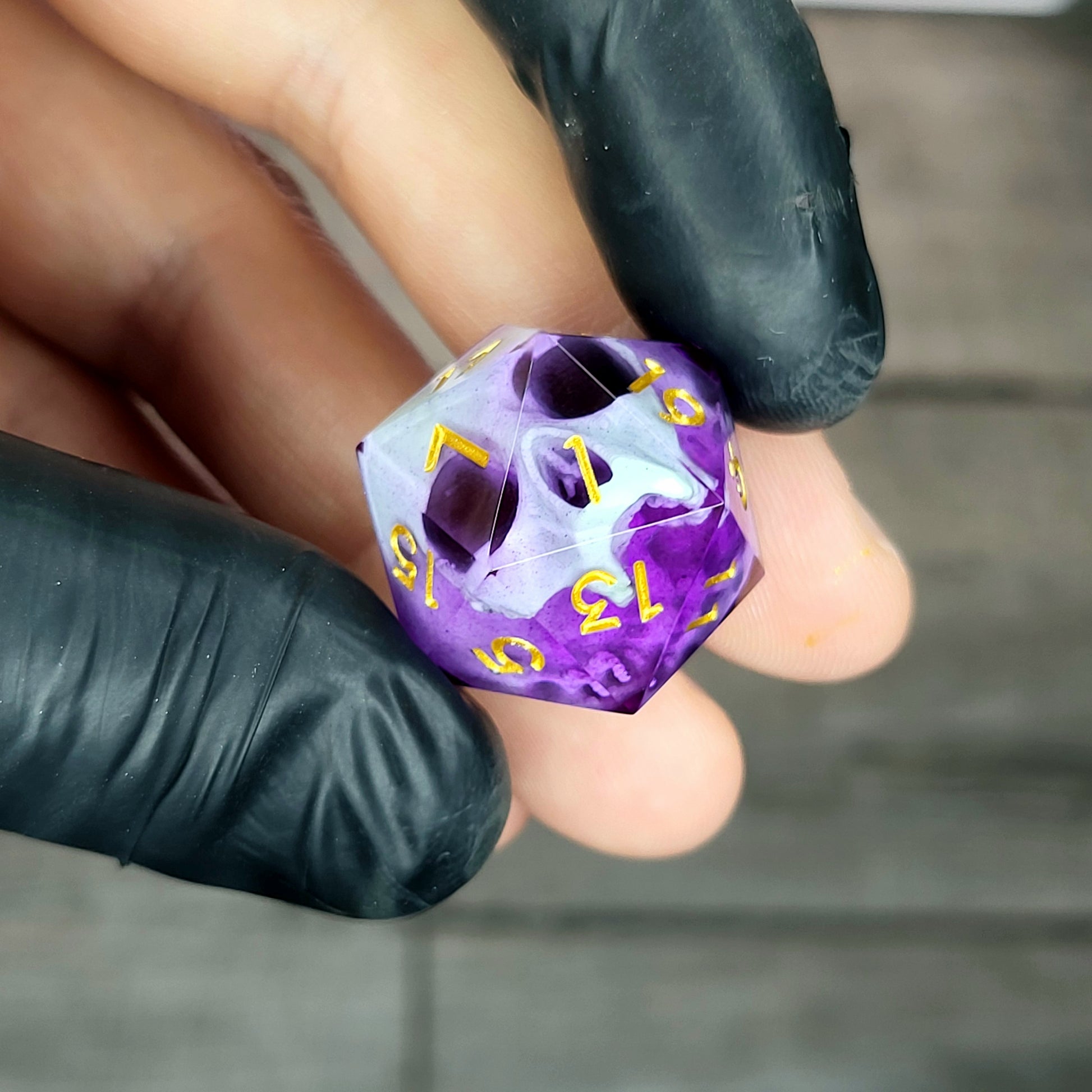This is a single set of one D20 DnD die with a light green skull inside , purple resin and gold numbers