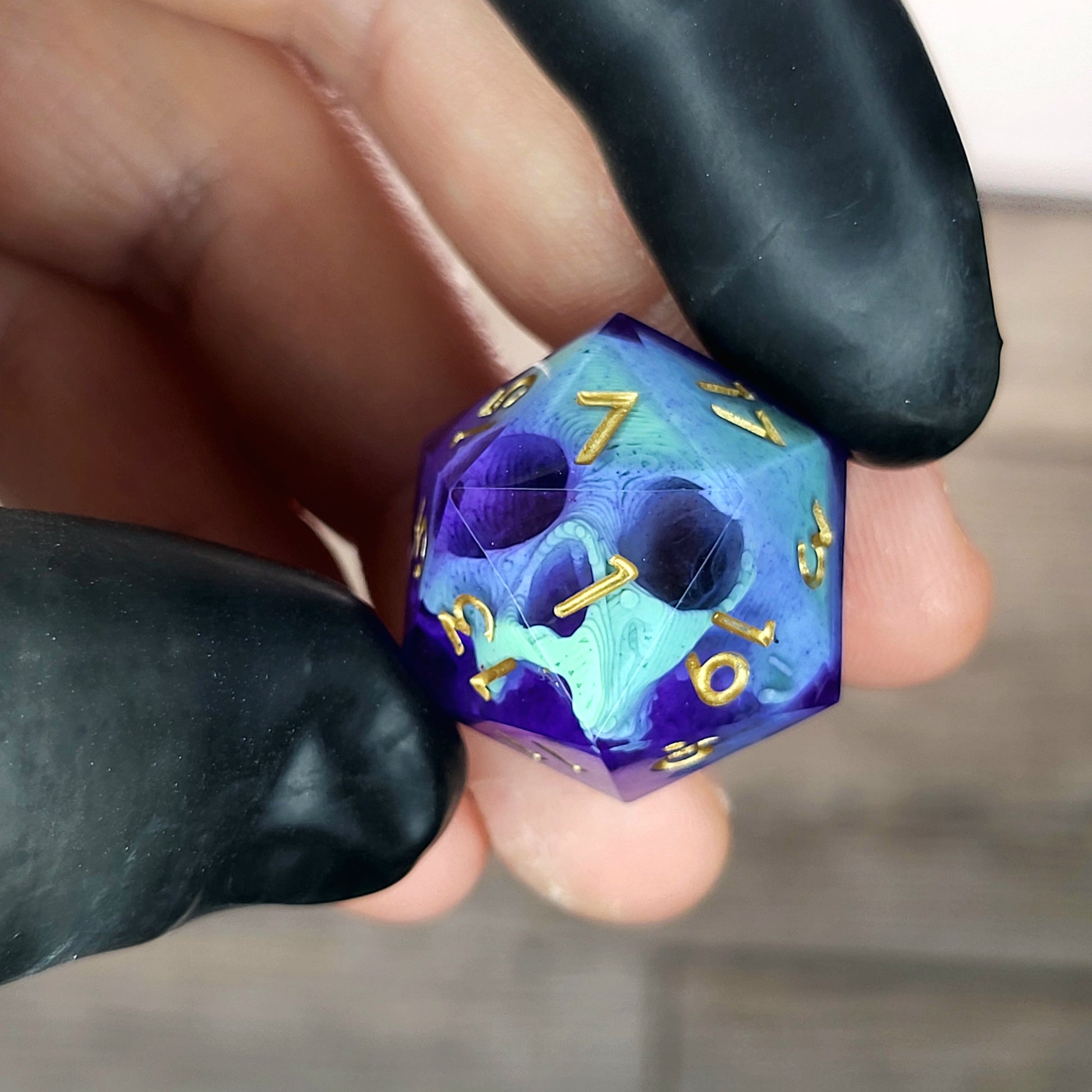 This is a single set of one D20 DnD die with a light green skull inside , purple resin and gold numbers