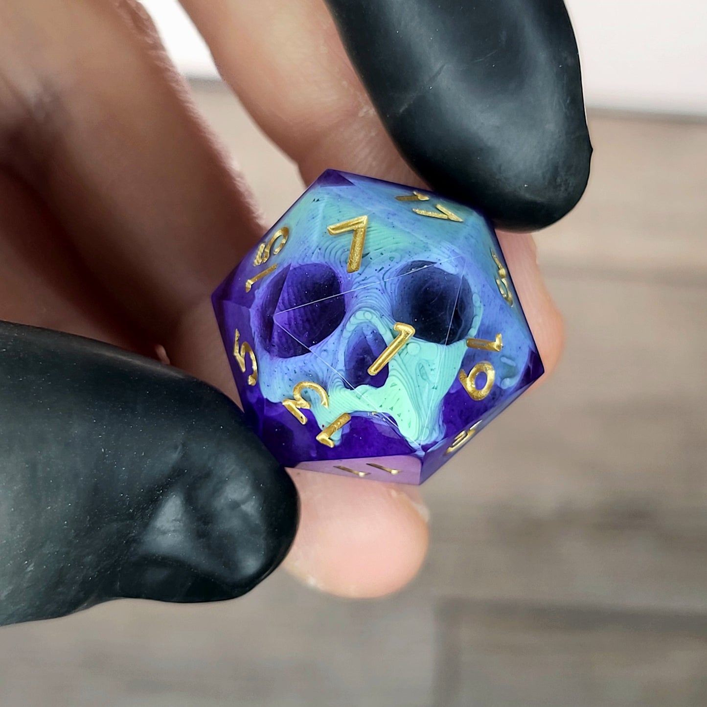 This is a single set of one D20 DnD die with a light green skull inside , purple resin and gold numbers